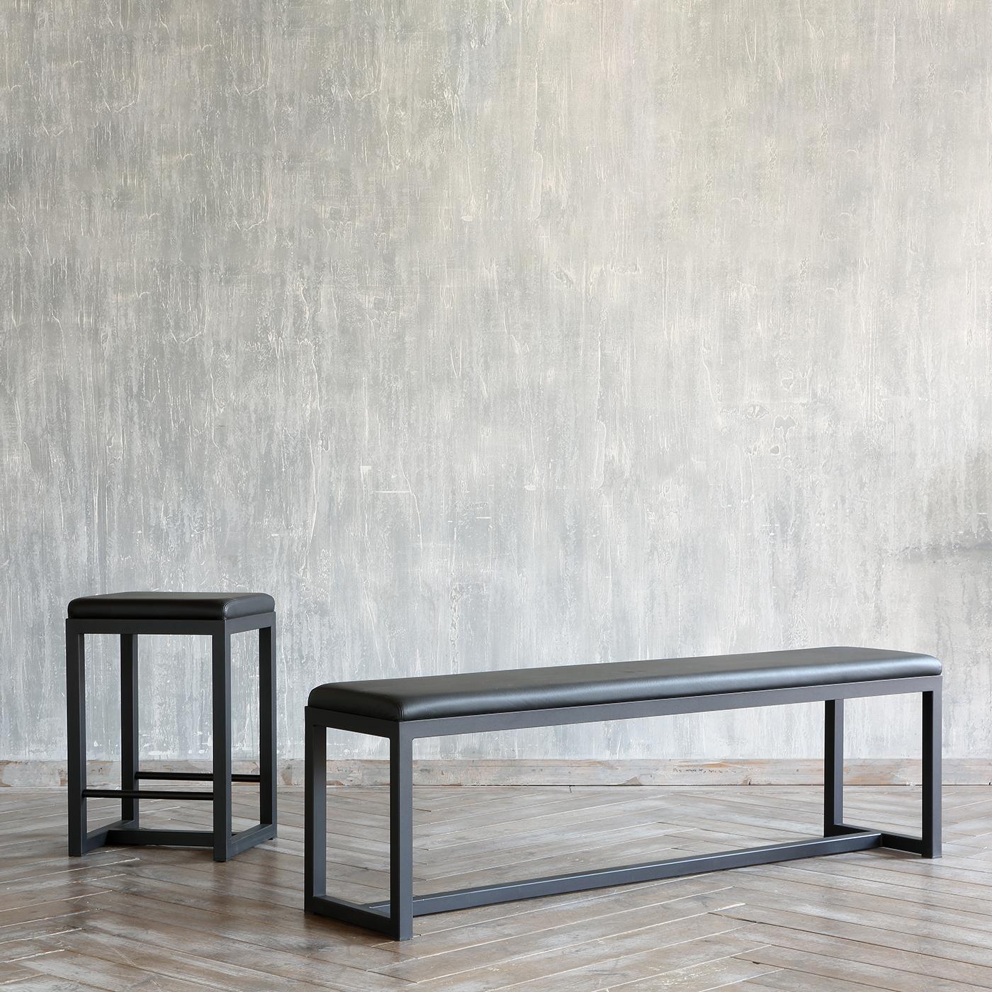 Generously padded and covered with fine black leather, the linear 48cm-high seat of this exclusive bench states its sophisticated allure at first glance. A linear bar joints the elements otherwise making up a sleigh structure, fashioned of copper