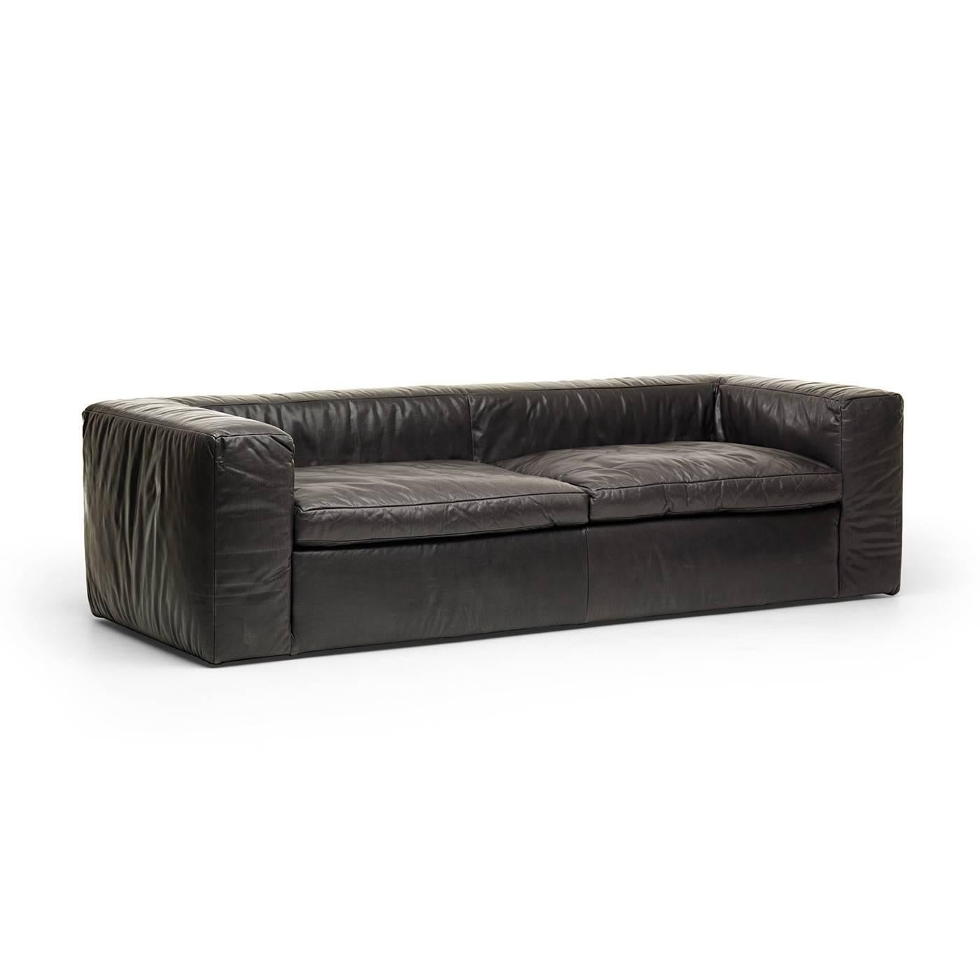 The essential silhouette of this sofa and its comfortable, plush cushions make it a sumptuous piece that will enliven the look of an Industrial-style or contemporary living room. This superb piece was designed by Alberto Colzani in 2013. Its