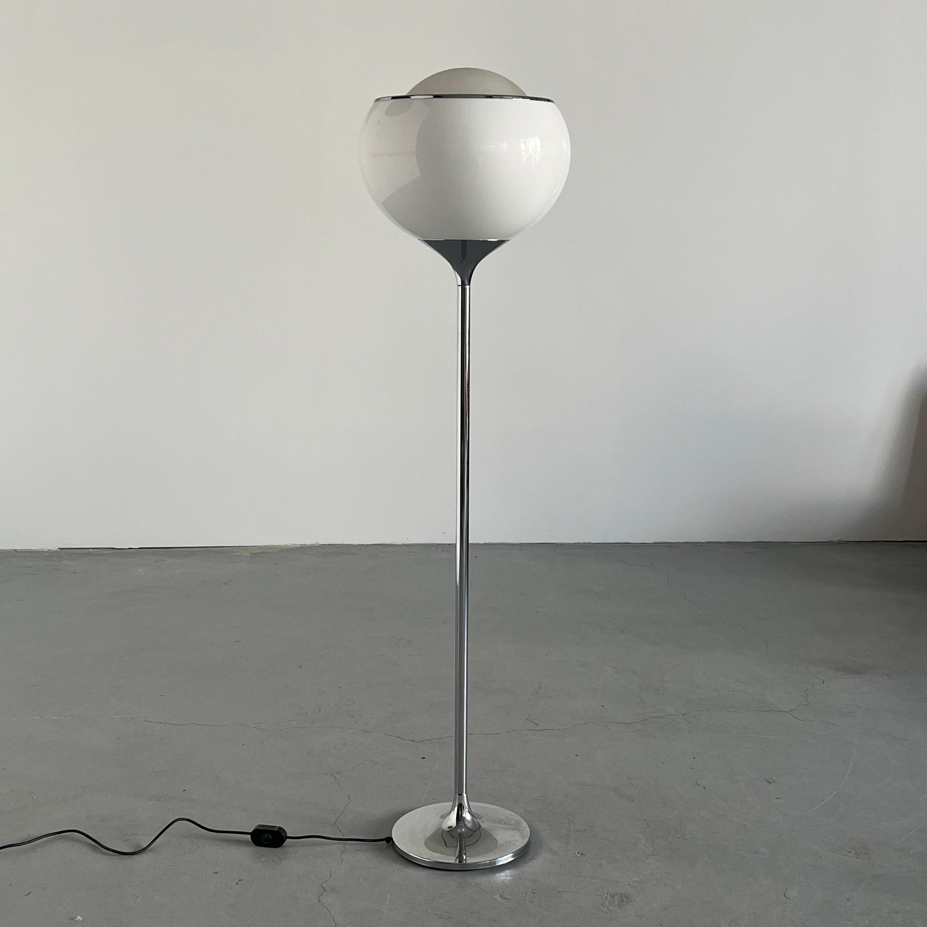 A sculptural Space Age floor lamp designed by Harvey Guzzini in Italy, 1968. Known as the Big Bud, this striking model features a double-layered acrylic globe shade in white, supported by a slender chromed steel stem and weighted circular base.

The