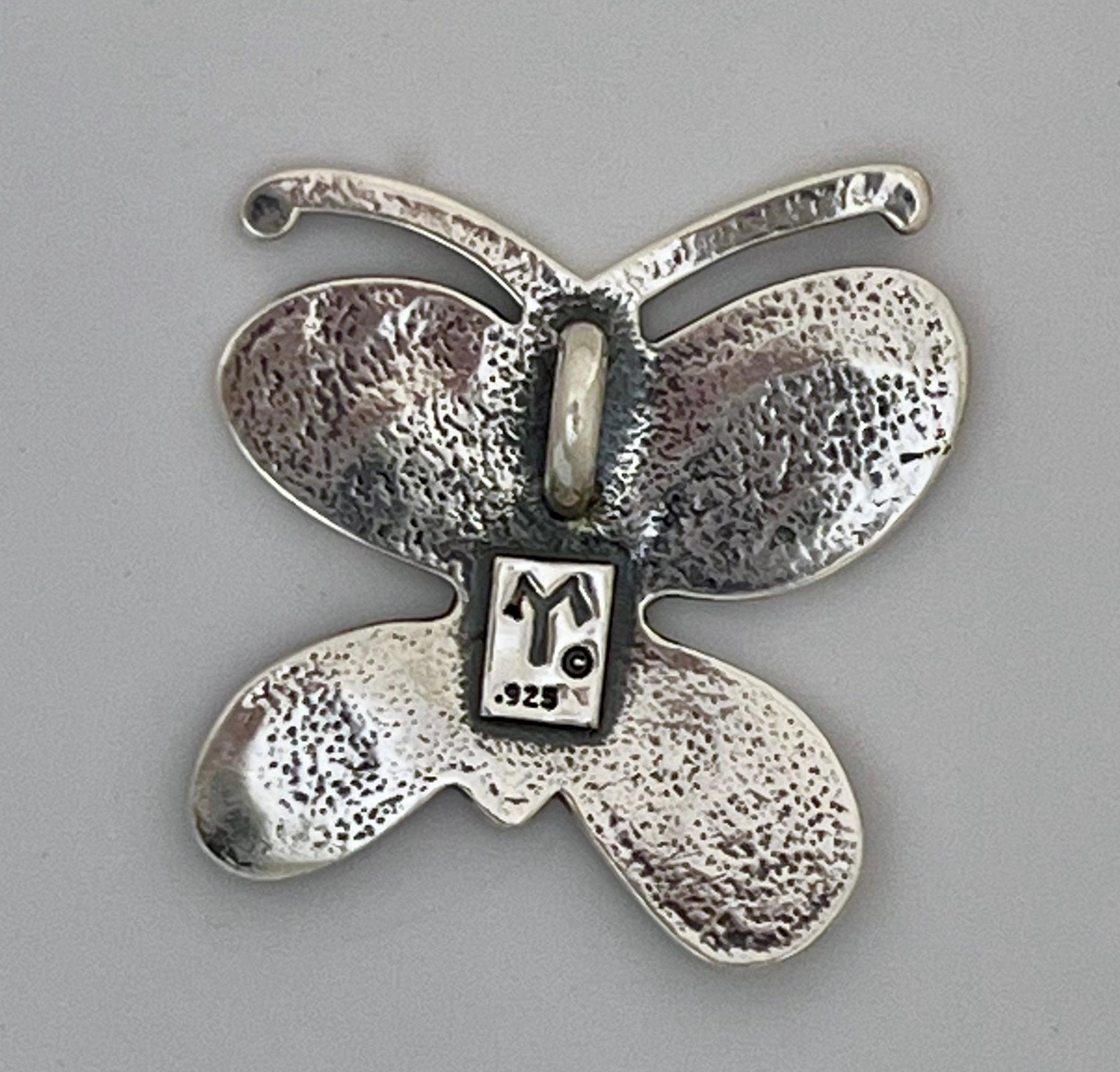 Big Butterfly Pendant, by Melanie Yazzie, Navajo, silver, black, contemporary

Melanie A. Yazzie (Navajo-Diné) is a highly regarded multimedia artist known for her printmaking, paintings, sculpture, and jewelry designs. She has exhibited, lectured,