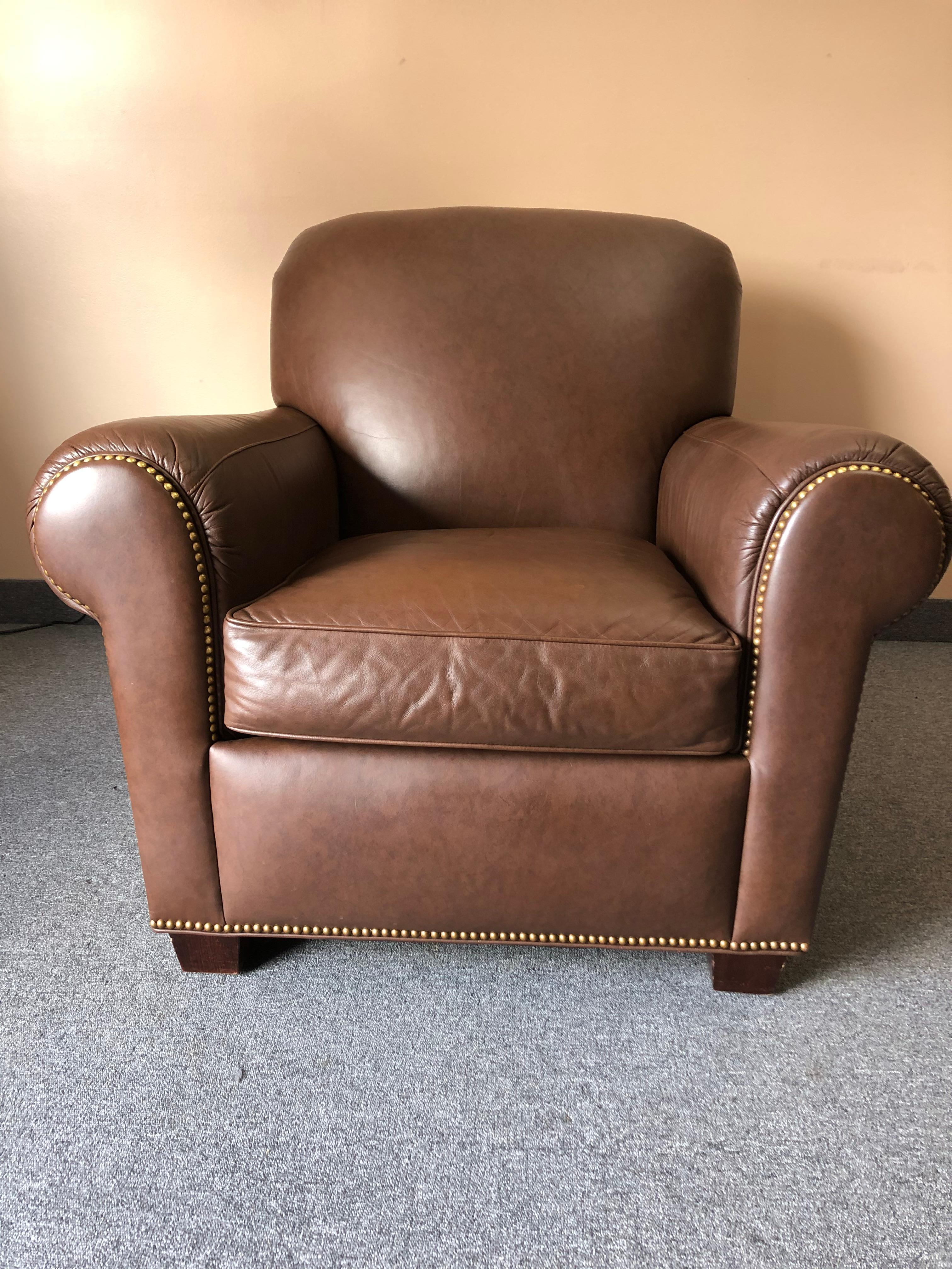 A big comfy classic soft brown leather club chair with curved arms finished with nailheads.
Measures: Seat depth 22
Arm height 26

Note: We have a second slightly lighter colored leather club chair that works to make a pair.