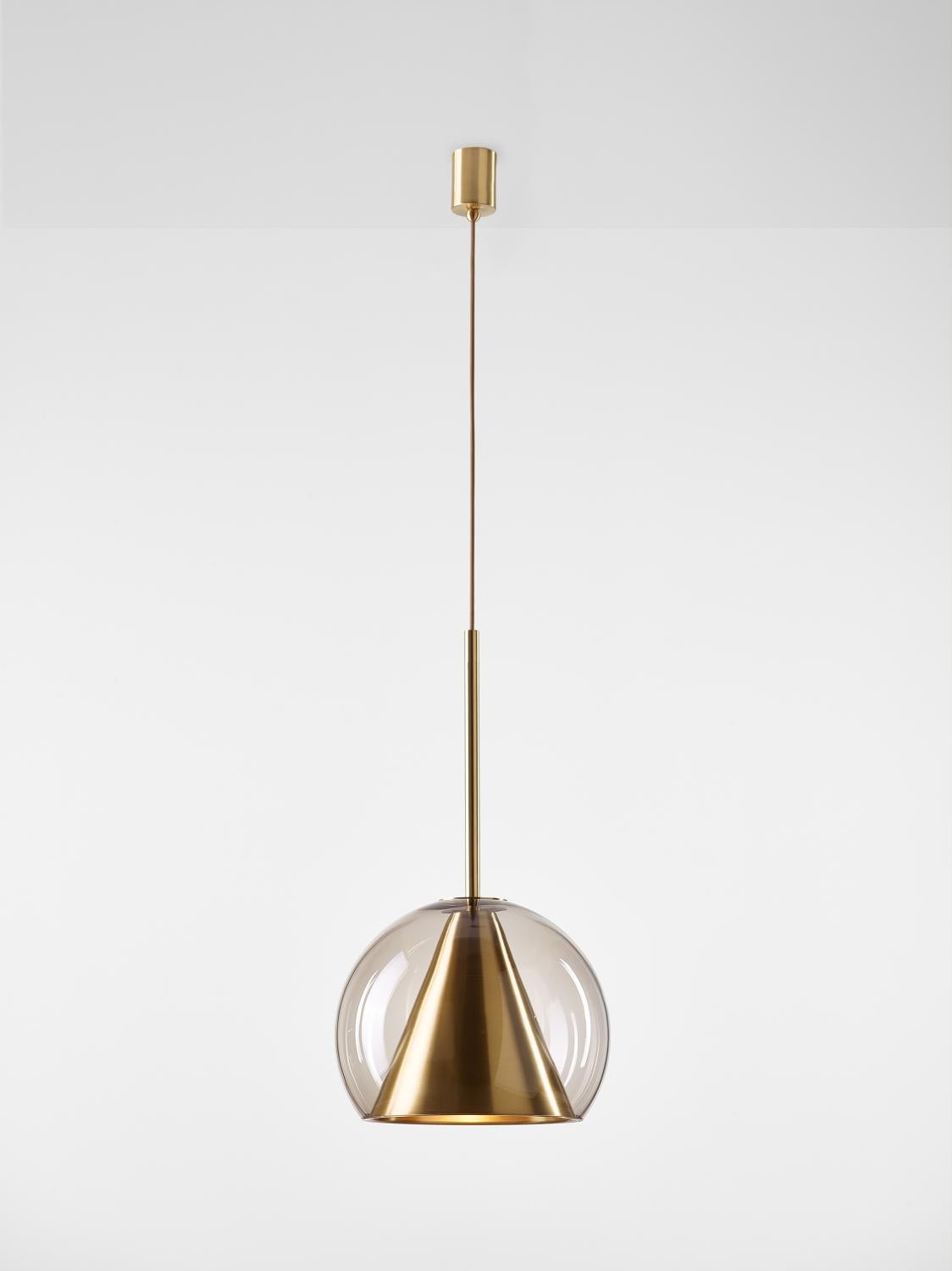 Big Crystal Clear Kono pendant light by Dechem Studio
Dimensions: D 35 x H 75 cm
Materials: Brass, Glass.
Also Available: Different finishes and colours available.

This collection of suspended light fixtures combines the elementary geometric