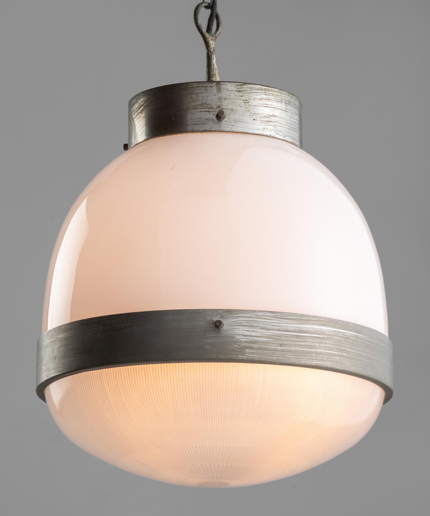“Big Delta” pendant by Sergio Mazza for Artemide, Italy, circa 1960.

Two part shade, with opaline on top and holophane on bottom secured with brass hardware.

Measures: 13.75