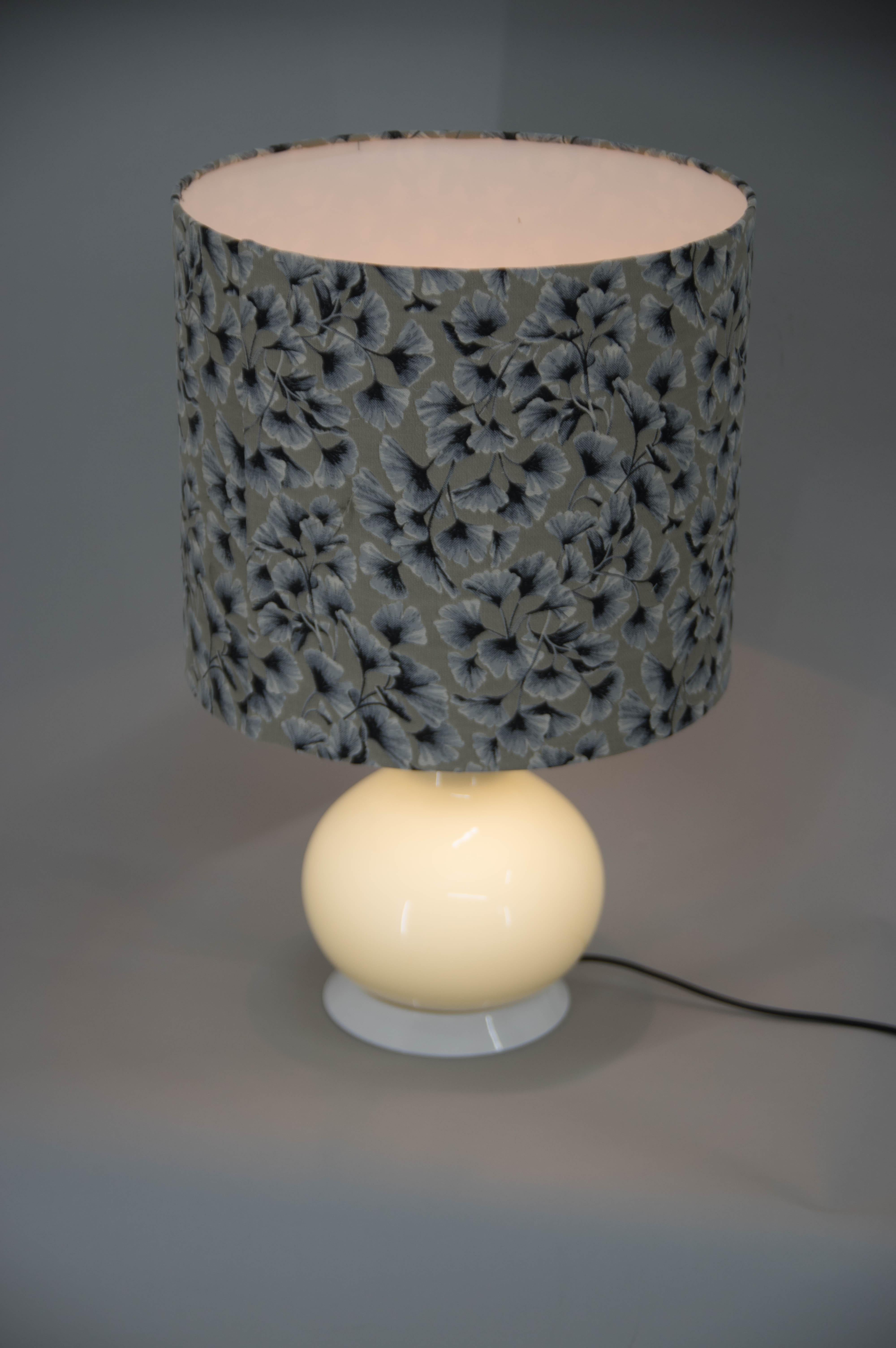 Big design table lamp with two separate circuits, one in glass leg and other in a shade.
New shade made of high quality fabric.
Two switches.
US plug adapter included.