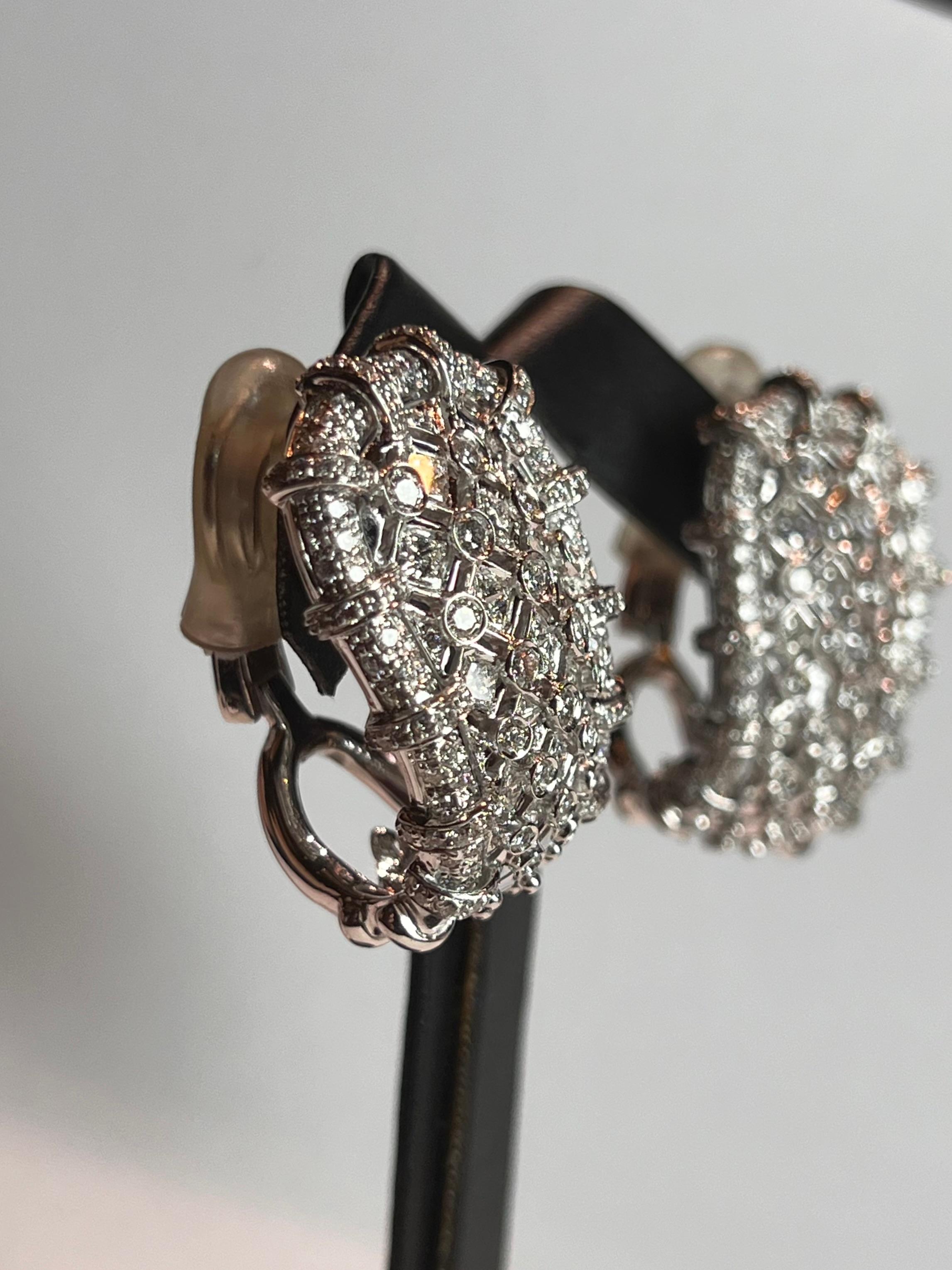This is a magnificent pair of Chandelier earrings with a twist! 12 carats of stunning, bright white VVS diamonds hang perfectly still from the ear. These exquisite earrings hold impressive size and impeccable craftsmanship, creating a mesmerizing