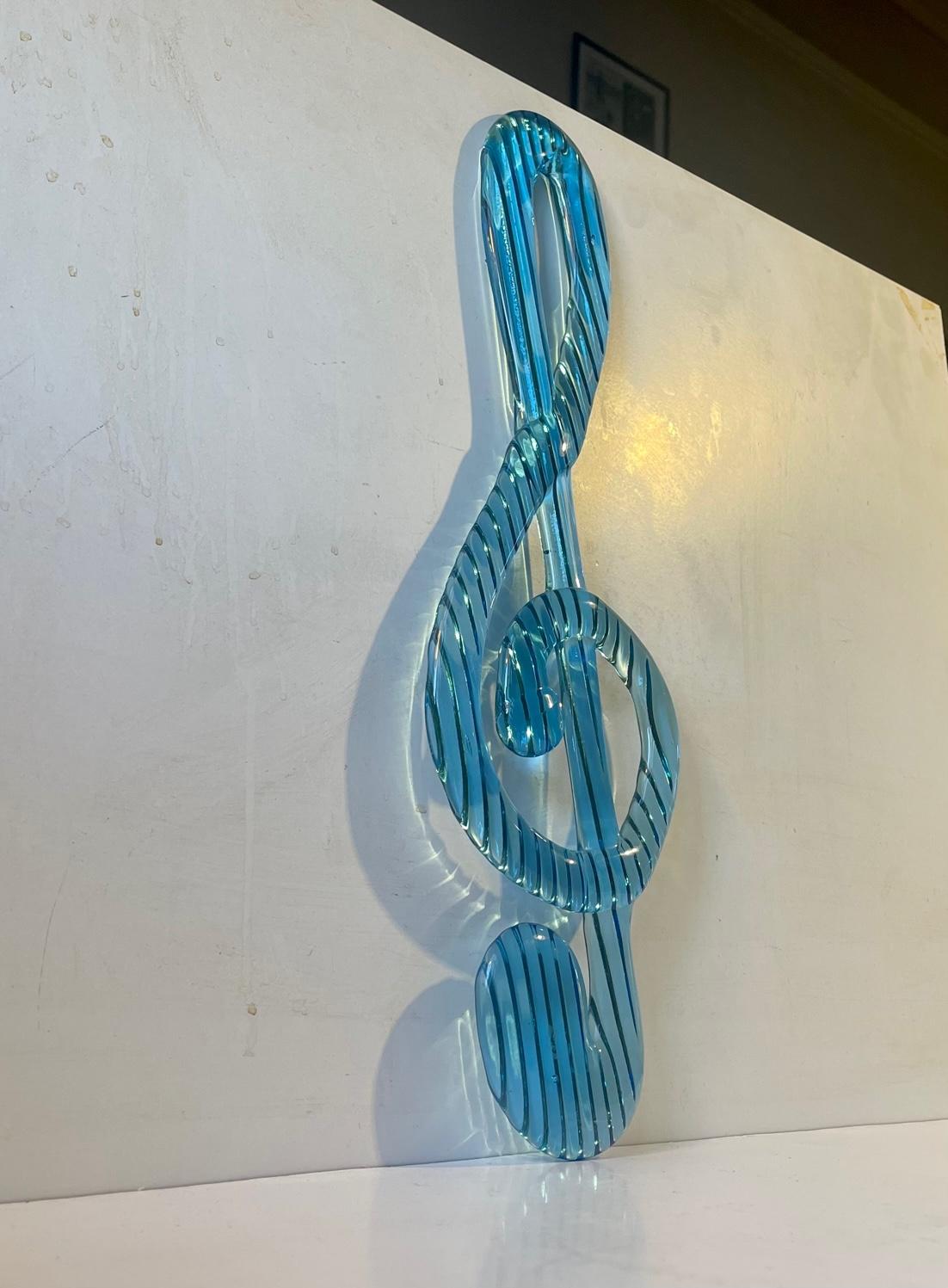 Beautiful mint/light blue glass G-Note glass sculpture/relief in fine intact condition. These wall decorations were produced from 1970 until 1983, at Bergdala Glassworks Sweden. They were all designed and handmade by glass-blower Elving Conradsson.