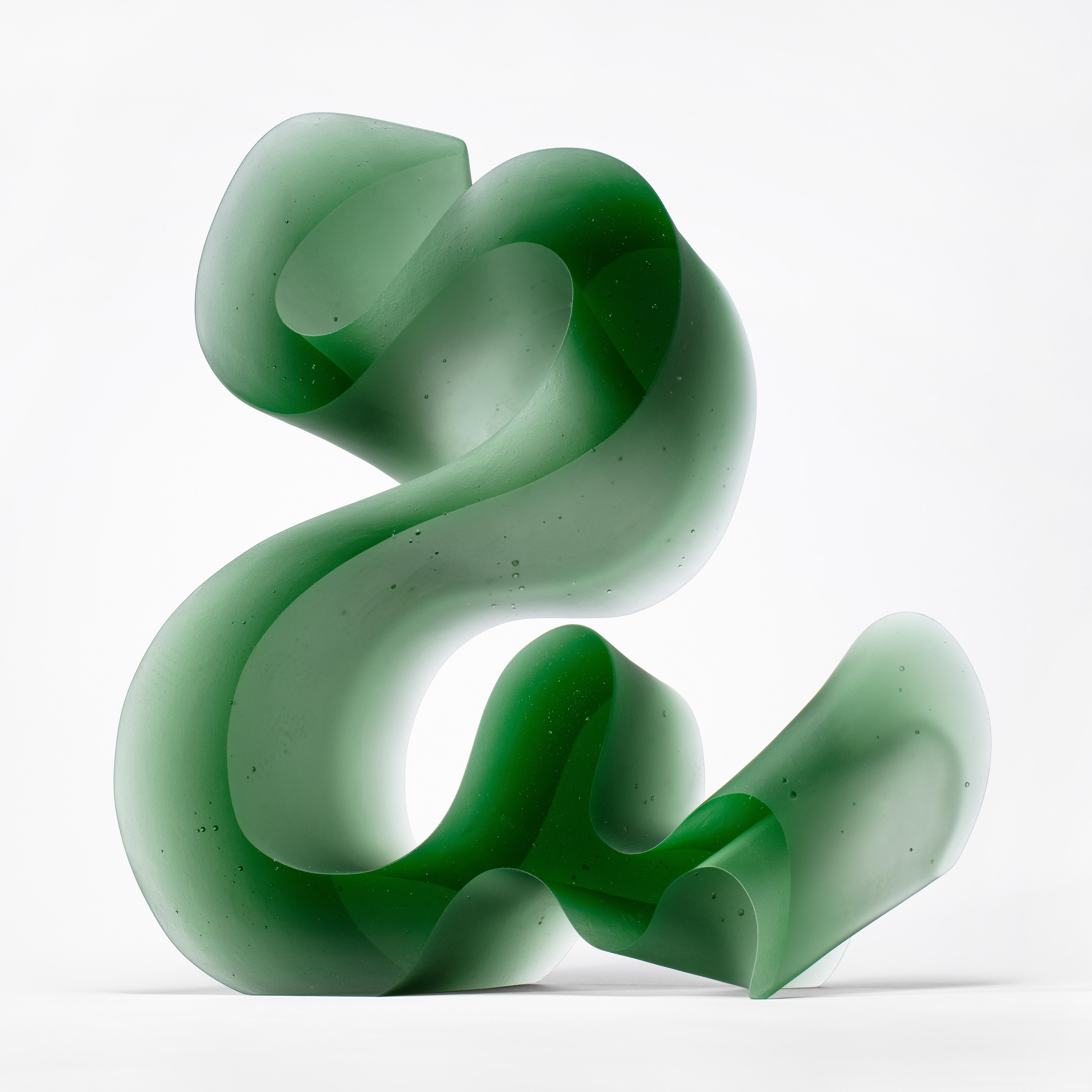 Big green line is a unique cast glass sculpture in green glass, created by the Danish artist Karin Mørch. Dramatic sweeping curves meander and follow the beautiful lines of this heavy and solid cast piece. Mørch intimately understands her glass and