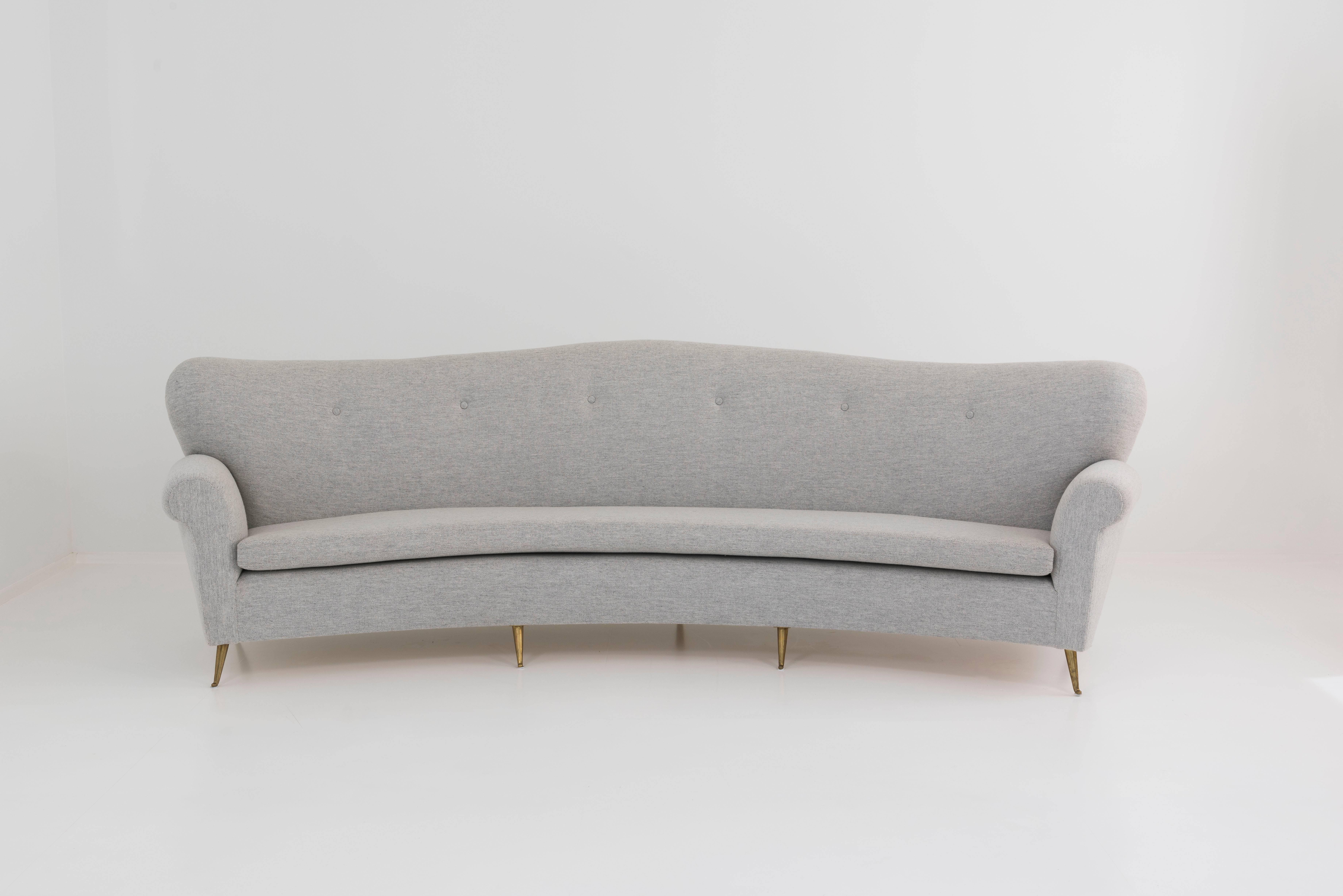 Big curved sofa with brass feet, good round form, clear gray upholstery fabric, unknown designer, Italy, circa 1950 

Measures: H 90 cm long 3 m prof 90 cm 
H 35.43