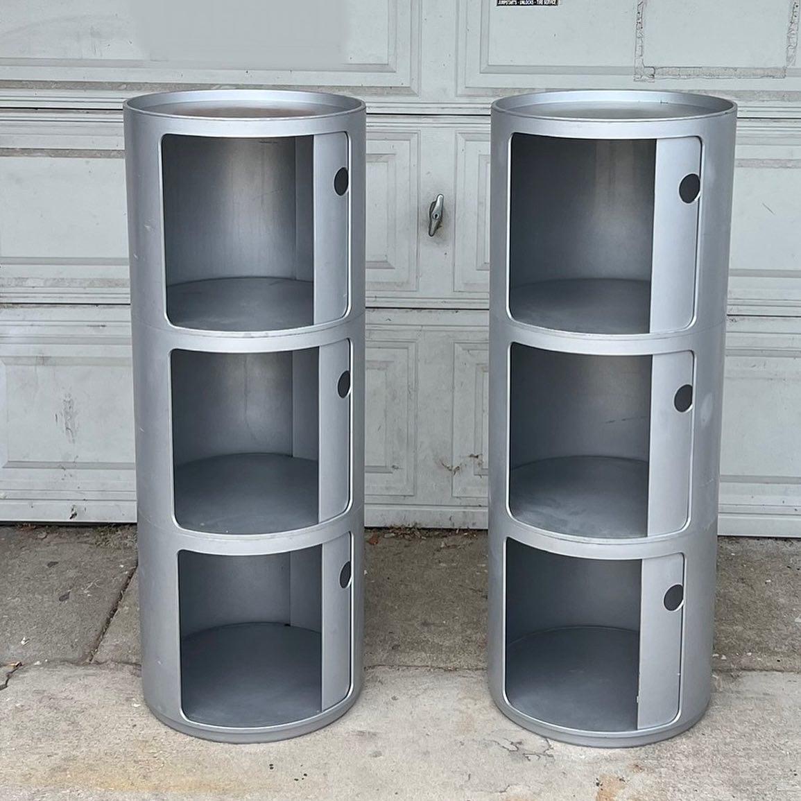 Two Kartell storage towers comprised of three tall modular units each- both in the color “painted aluminum.” Designed by Anna Castelli and made in Italy. Each are structurally excellent condition, though their backsides have had a rough go of it,