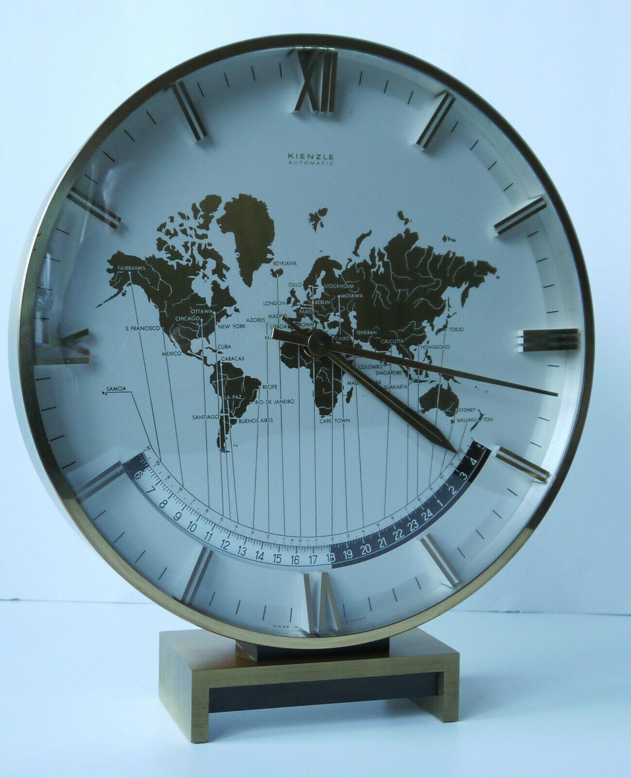 Kienzle automatic world timer zone clock.
An exclusive big table clock from Ø 26 cm wonderful clocks face with world map and world time zones, glass, the heavy case & base are of solid brass. Battery movement. The most of Kienzle clocks were