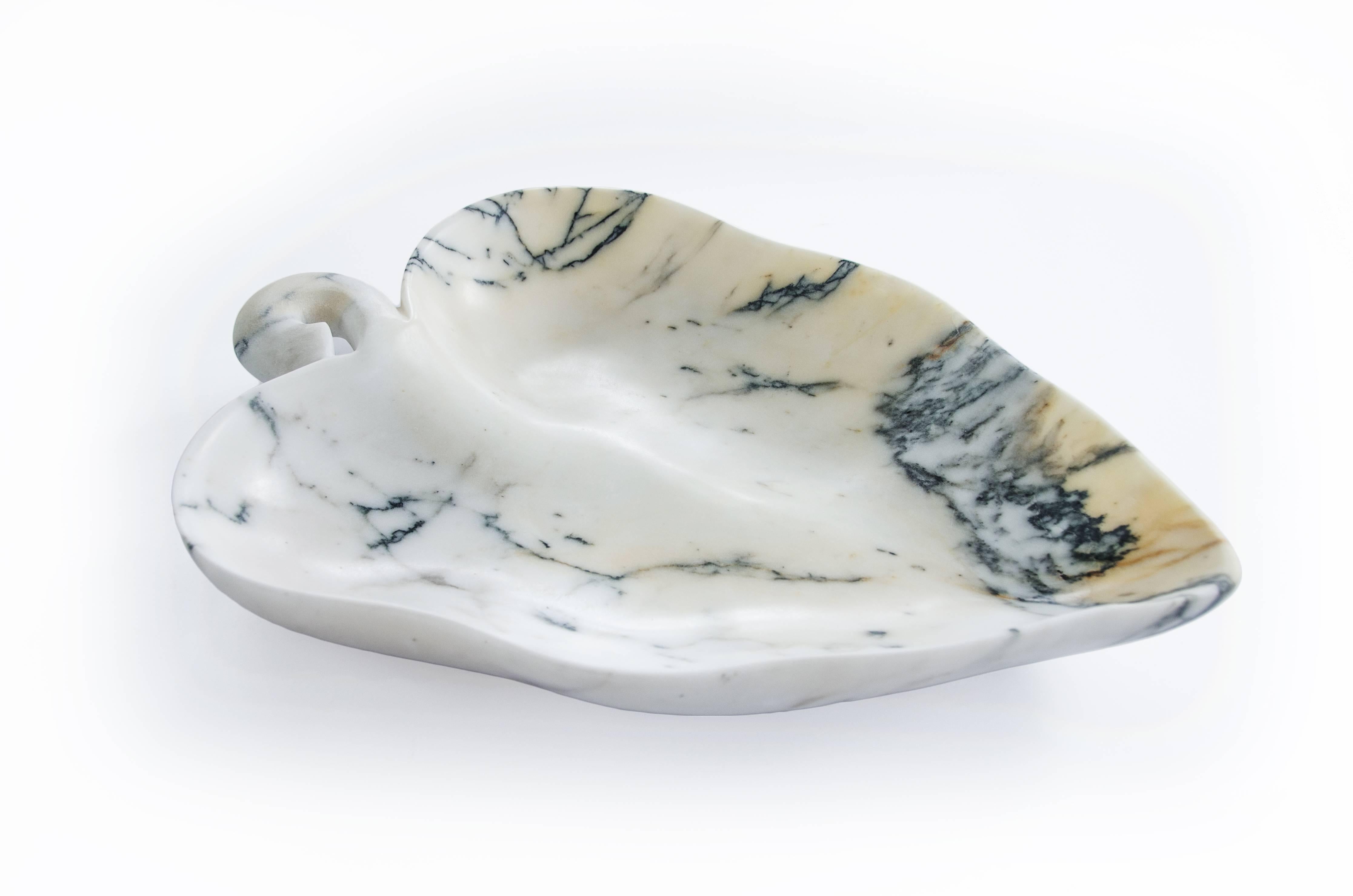 Big bowl in Paonazzo marble with the shape of a leaf. Each piece is in a way unique (since each marble block is different in veins and shades) and handmade by Italian artisans specialized over generations in processing the famous Carrara marble.