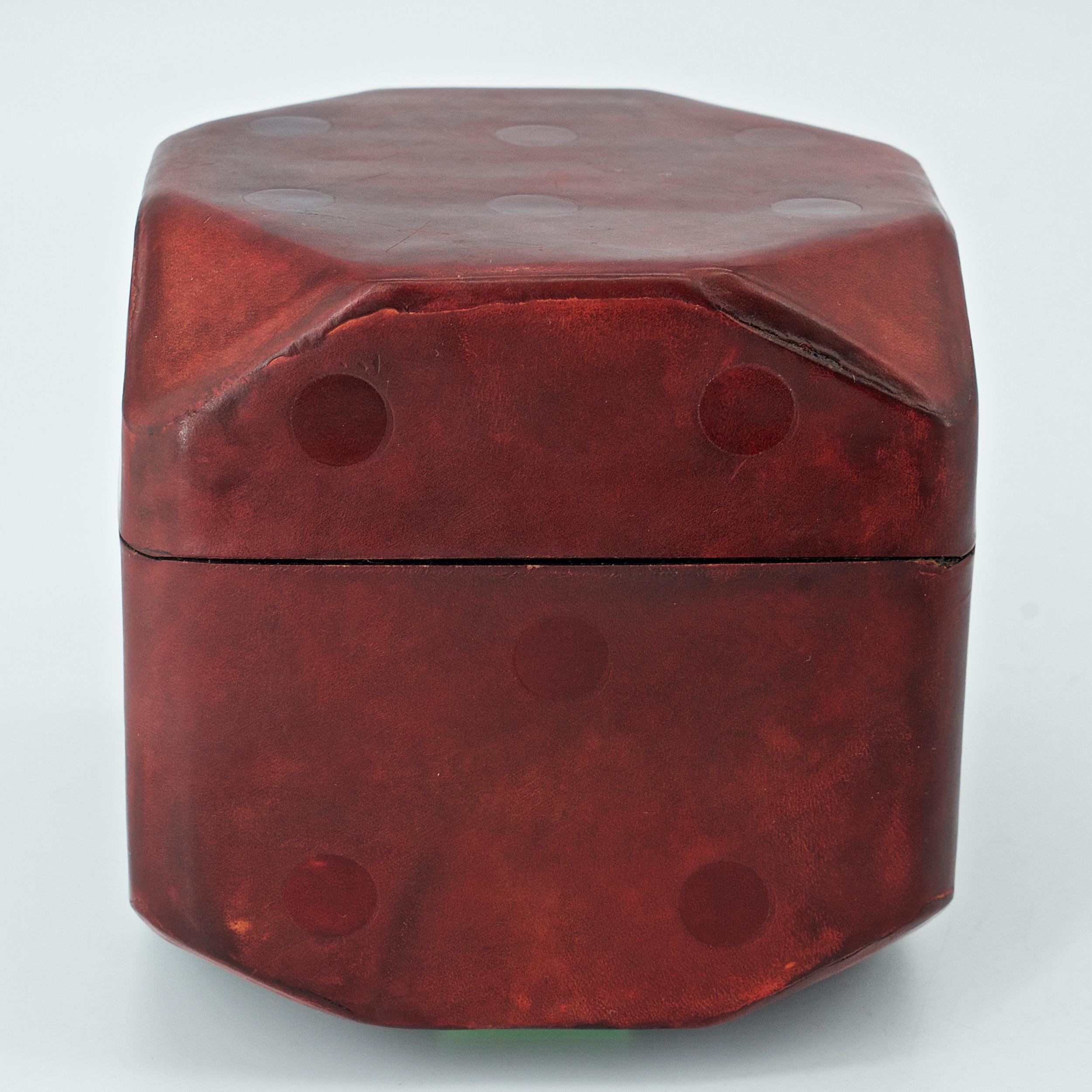 Nice worn red leather covered box in form of a die. Slotted interior for 3 decks of cards.