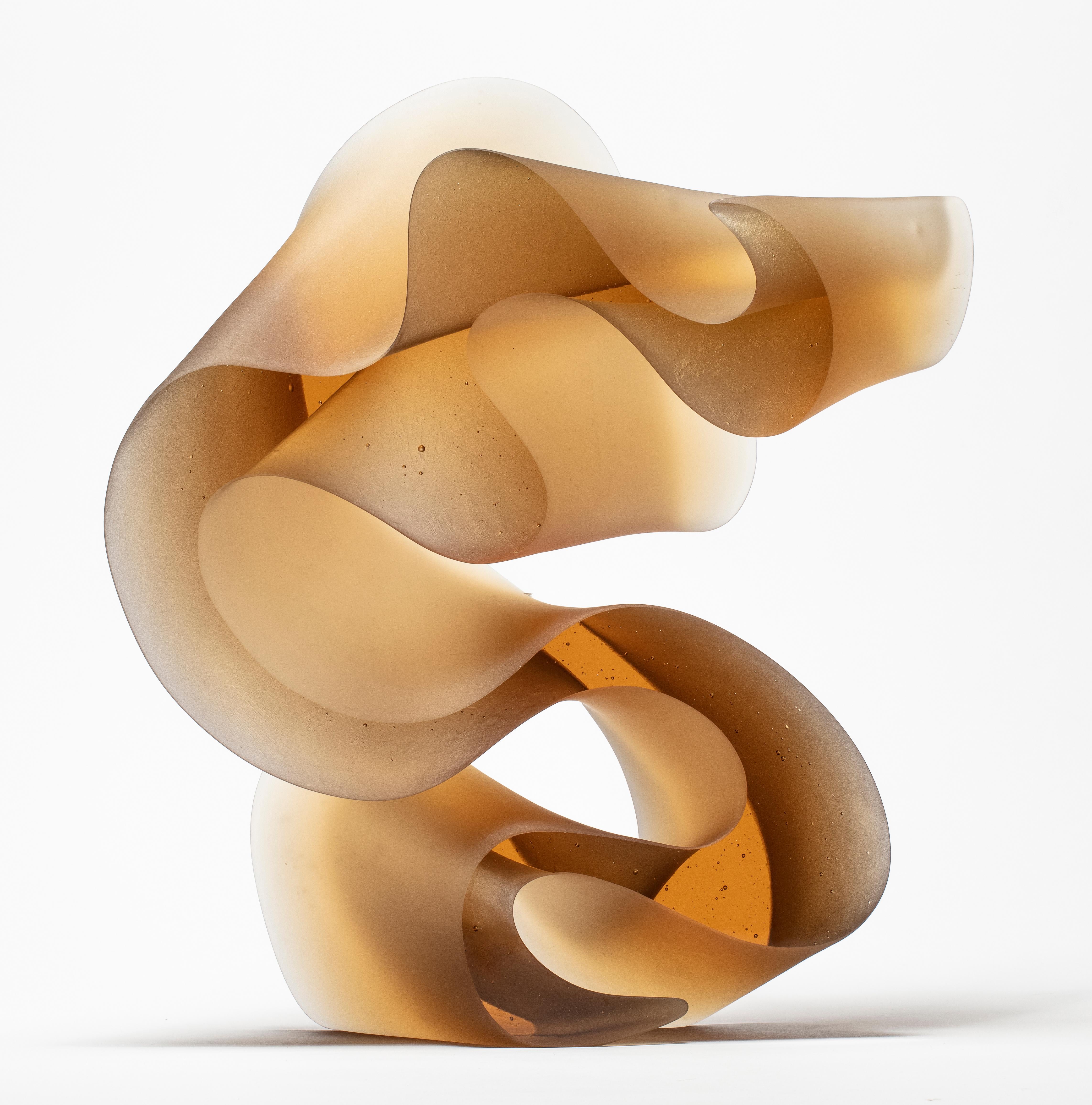 Big line in amber is a unique cast glass sculpture in amber glass, created by the Danish artist Karin Mørch. Dramatic sweeping curves meander and follow the beautiful lines of this heavy and solid cast piece. Mørch intimately understands her glass
