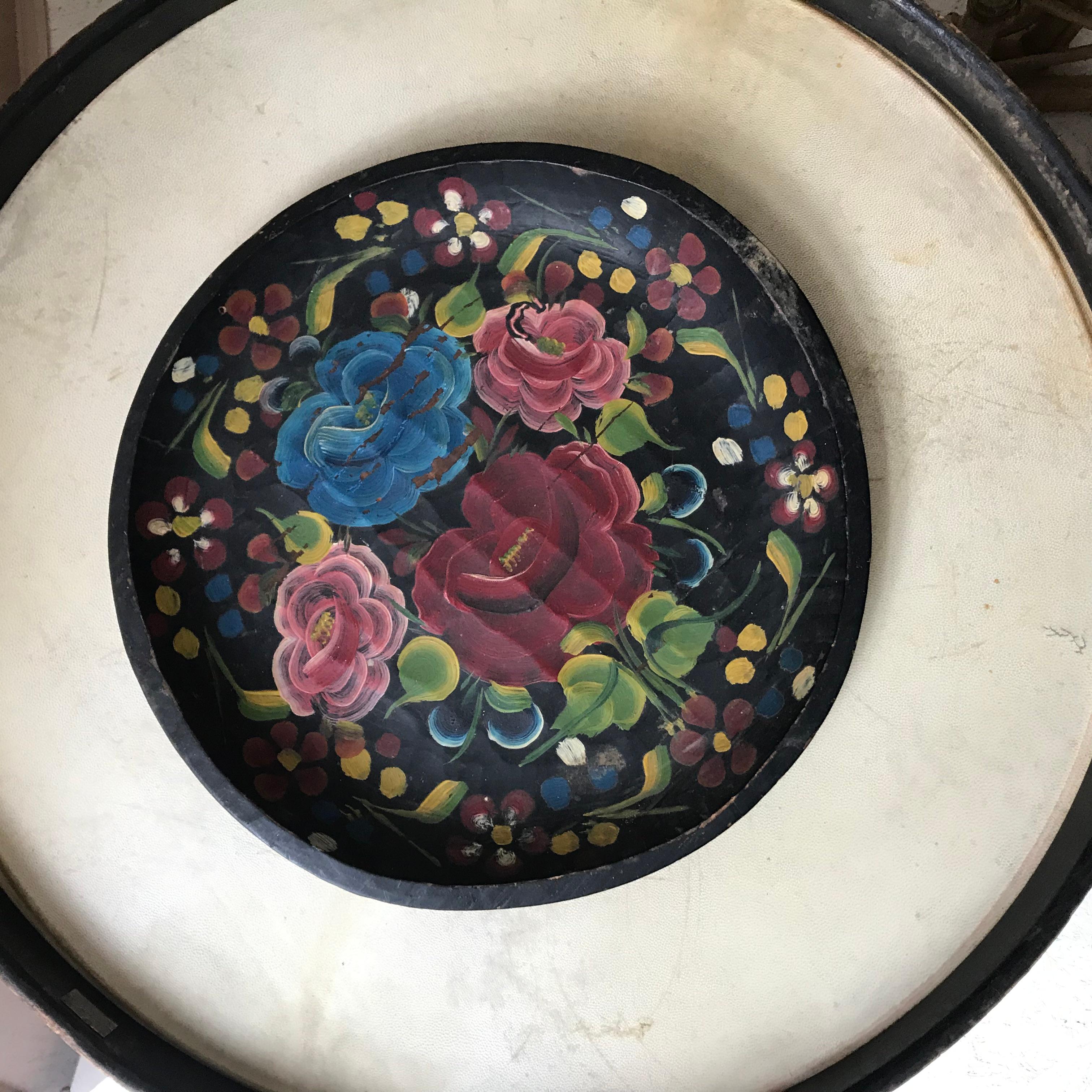 A beautifully crafted Mexican wooden plate featuring a black base and vibrant hand-painted flowers. This piece combines traditional craftsmanship with colorful artistry, perfect for adding a cultural touch to any space.