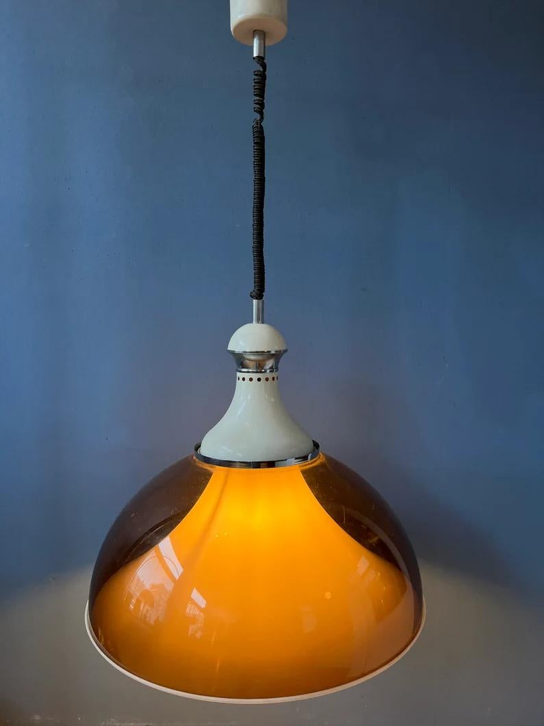 Very large mid century Stilux Milano space age pendant lamp with double acrylic glass shade. The lamp consists of an acrylic glass copper coloured outer shade and a white inner shade. The height of the lamp can be adjusted with the rise-and-fall