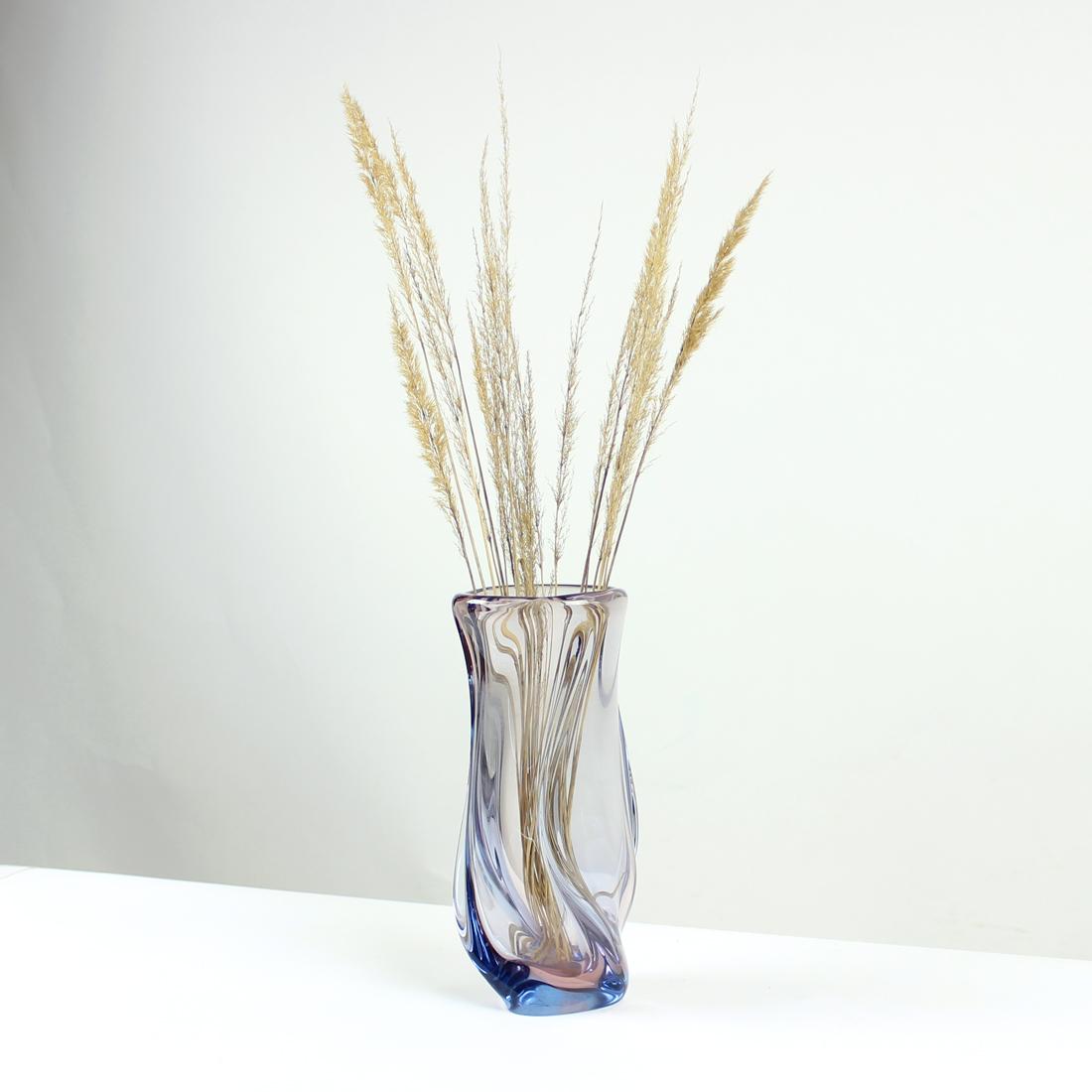 Big and heavy vase made of an art murano glass. Produced in Czechoslovakia in 1960s by Josef Hospodka and Skrdlovice Glass Factory. The vase is in transparent glass with slight blue shade. The shape is super elegant as it twists slightly. The glass