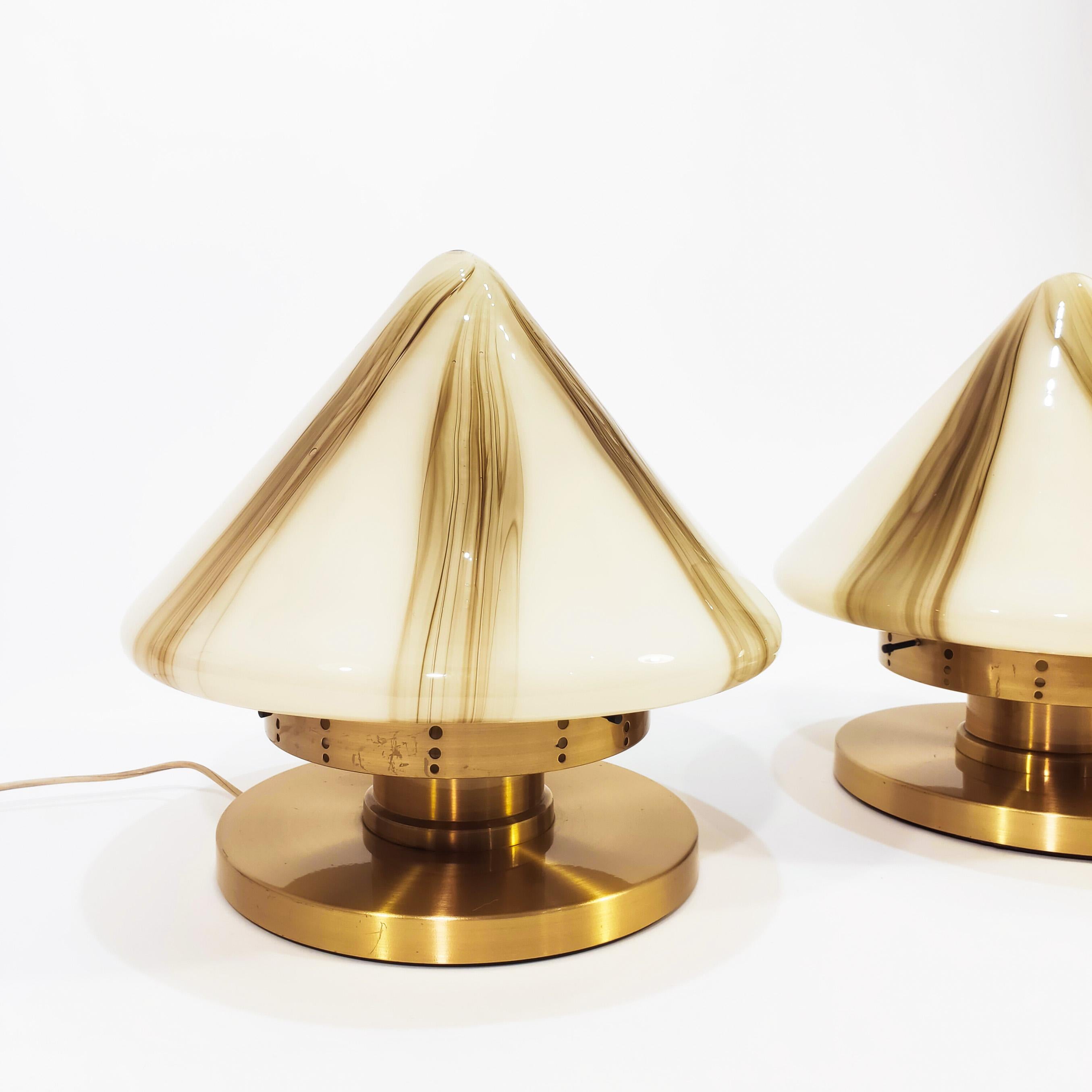 Pair of big table lamps from the 70s, in the style, design and manufacture of the Italian glass brand F. Fabbian. The shade is conical in two-tone Murano glass and the structure is polished brass, which has a cushioned system on the central axis to