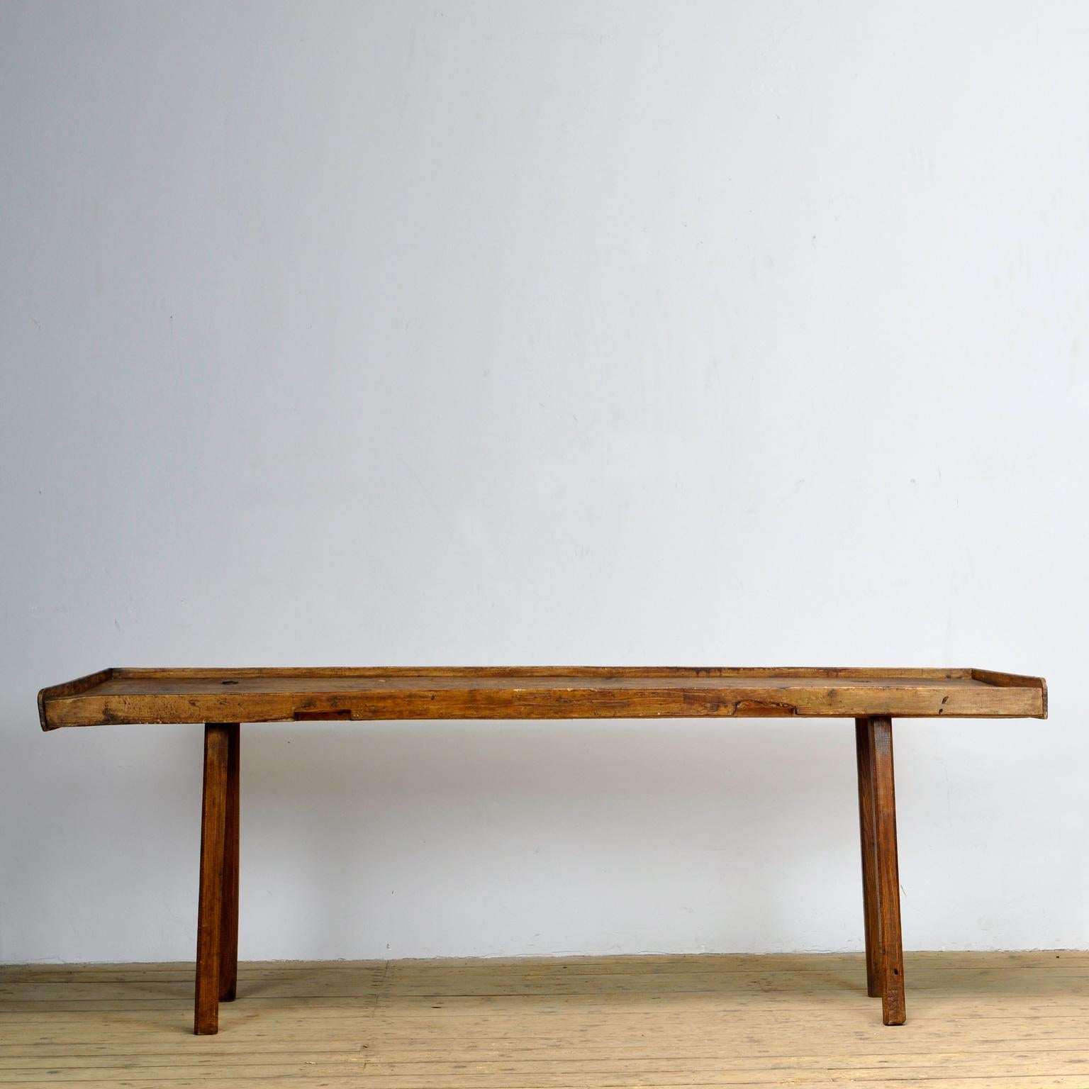 Large oak farm preparation table. Made around 1920. The table has a raised edge at the back and sides. The top widens. The top is 230 cm at the back and 249 cm at the front. The table is sturdy and free from woodworm.