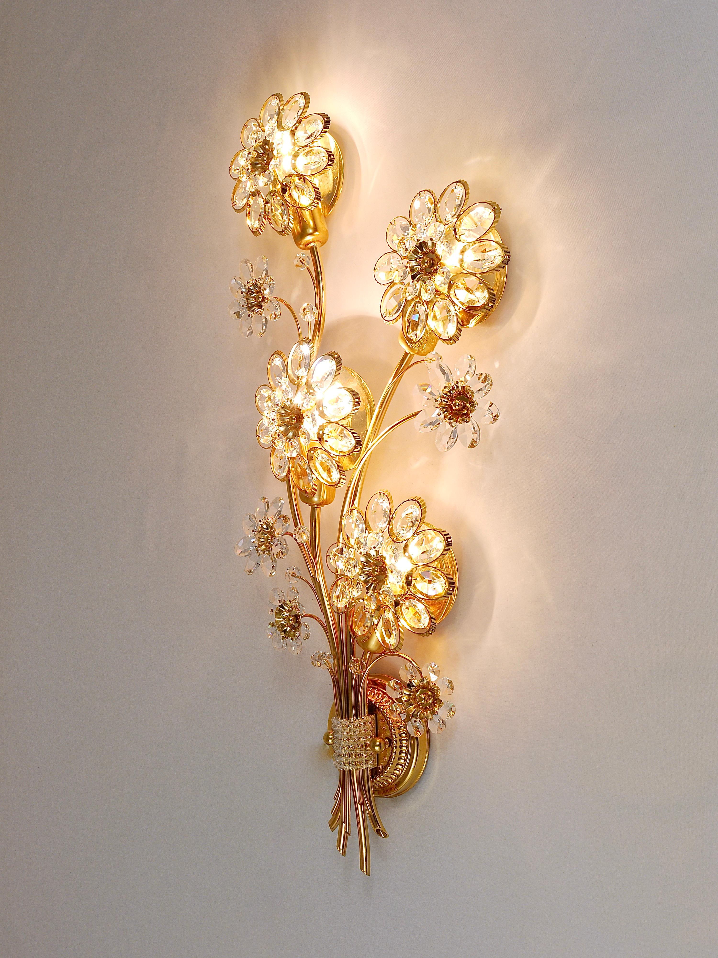 A beautiful and huge floral sconce, manufactured in the 1970s by Palwa, Germany. Made of gold-plated brass with faceted crystal glass petals. In excellent condition.