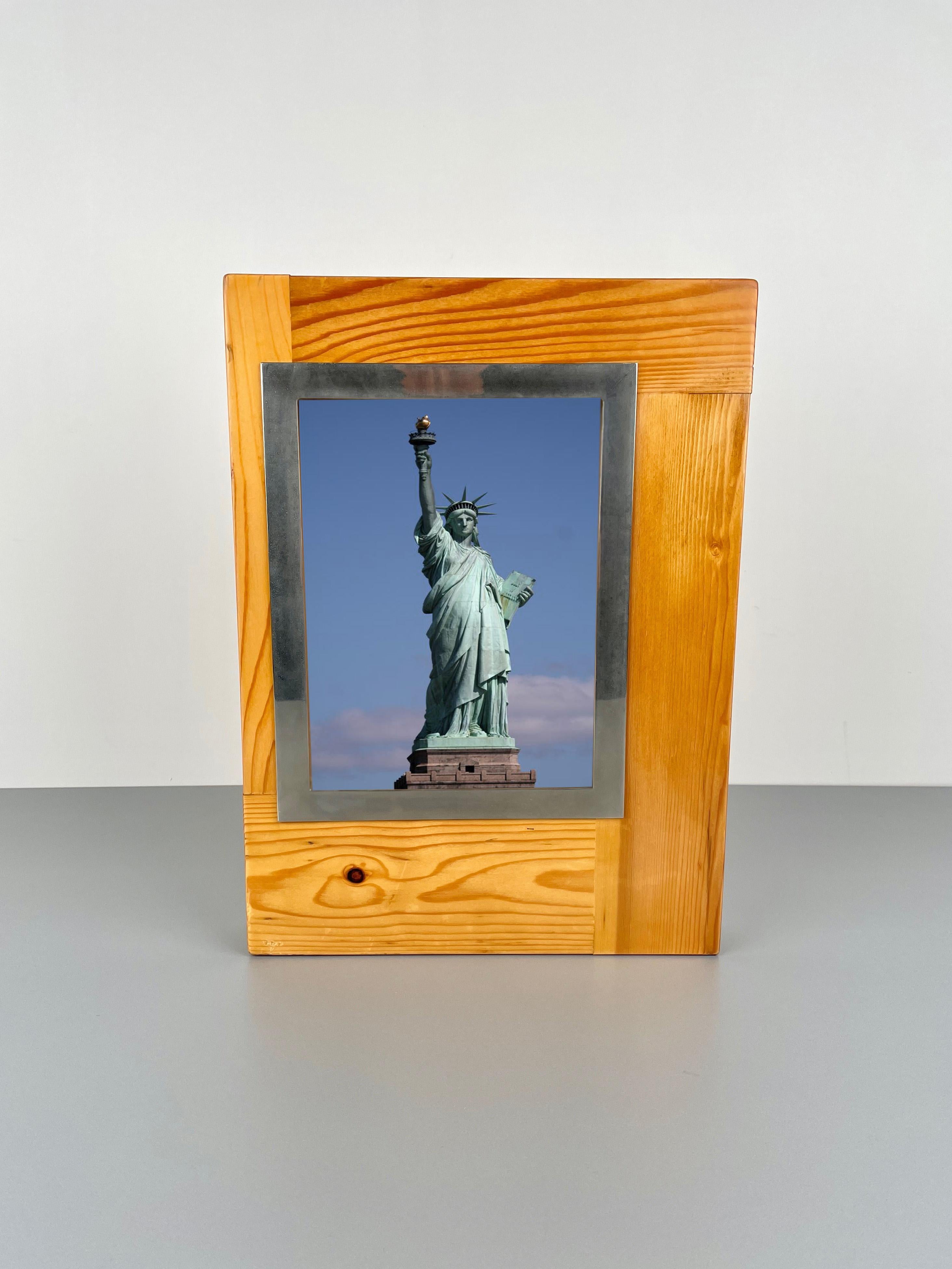 Big picture frame in pine wood with steel borders made by the Italian designer Felice Antonio Botta in the 1970s. 
The original label is still attached on the glass, as shown in the photos. 

The frame fits a picture with the following measures: