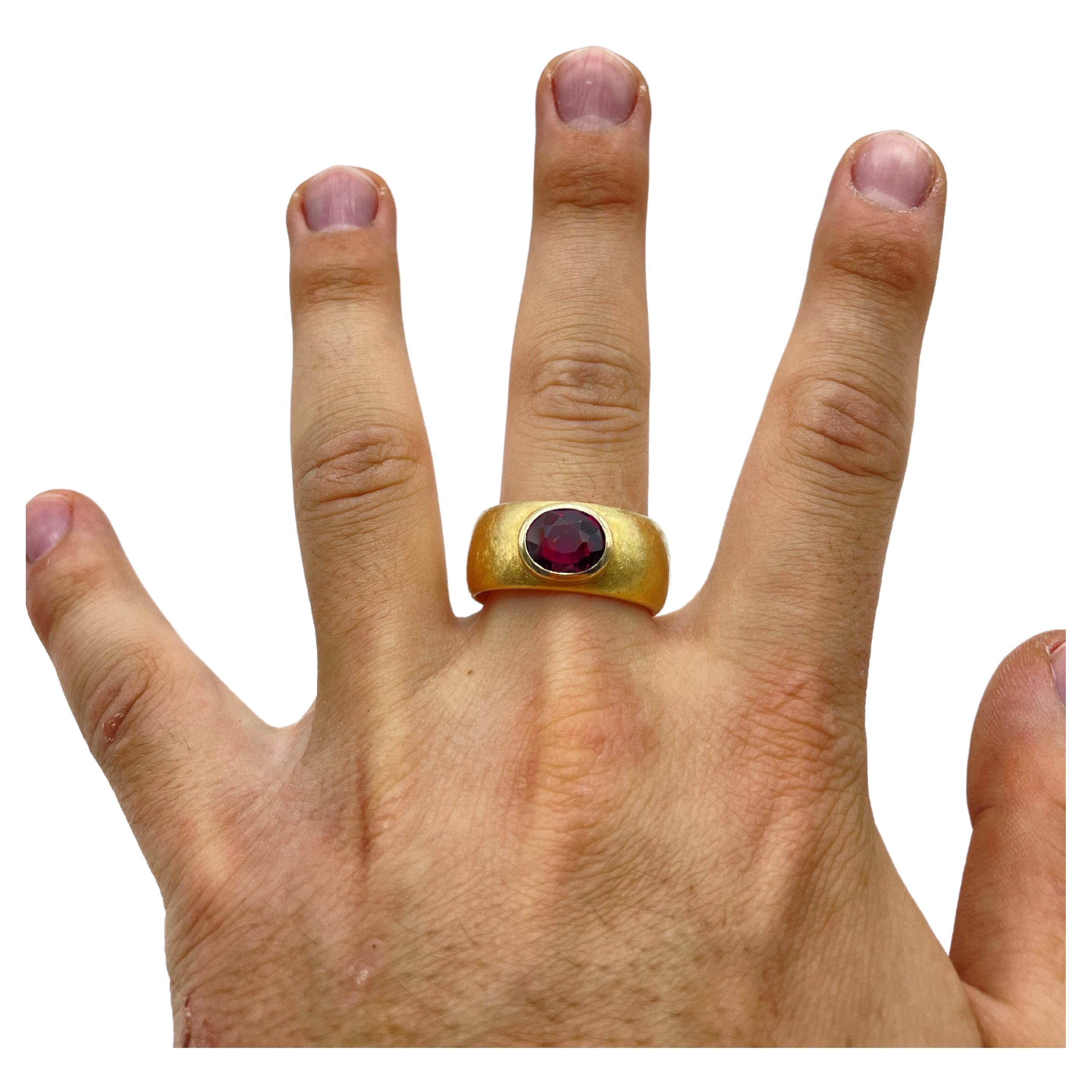 Introducing the majestic and powerful men's ring adorned with a commanding rhodolith in an oval cut. This remarkable ring is not for the faint of heart—it exudes strength and asserts dominance. With a weight of 29.5g, it carries a substantial