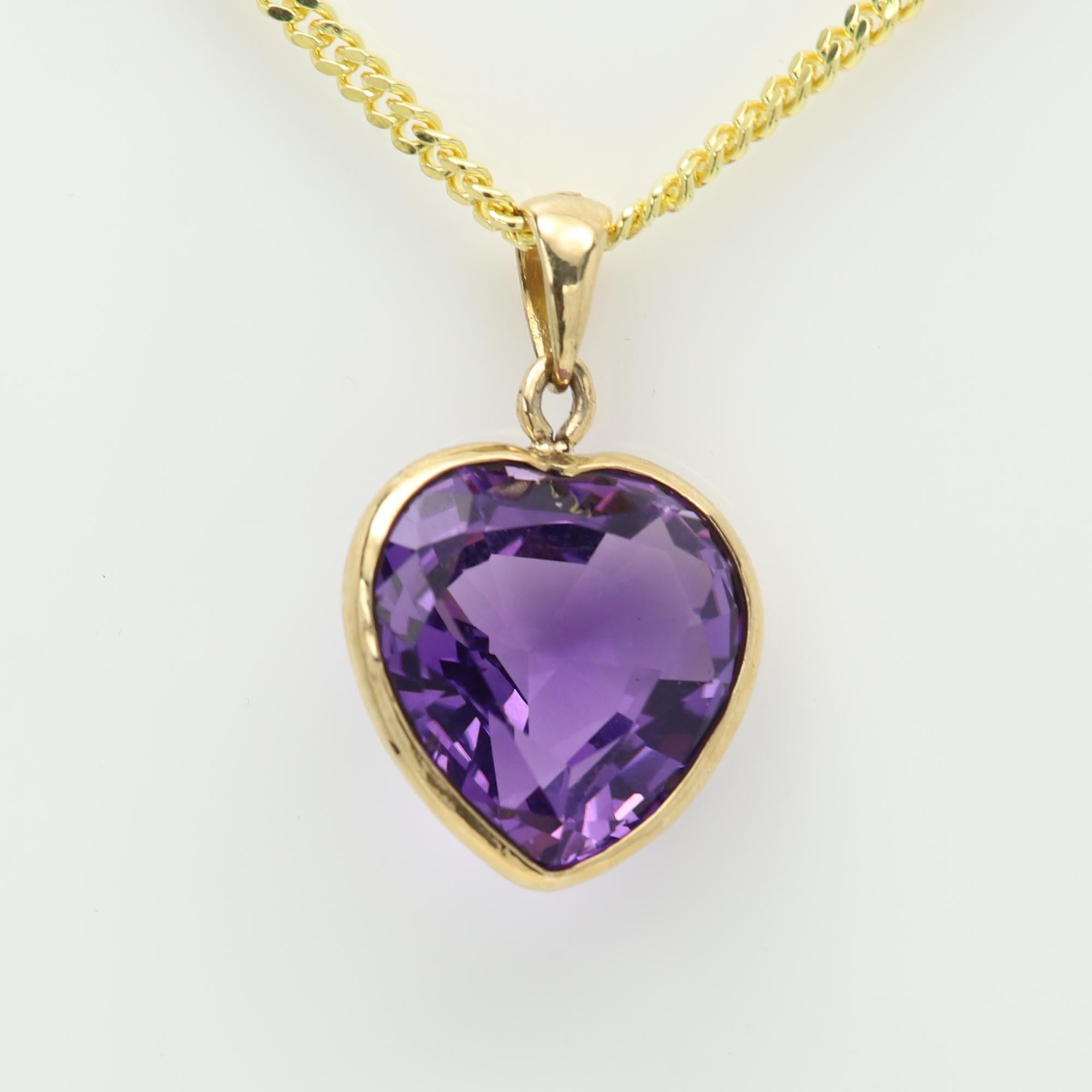 Large Purple Heart Pendant 
Heart shape 13.60 carat 
Deep Purple Amethyst Nice Brilliant Rich purple tone Color.
Natural Amethyst Gemstone
Bezel set in 14k yellow gold total weight 3.6 grams (without the chain)
Size: approx 15 mm in