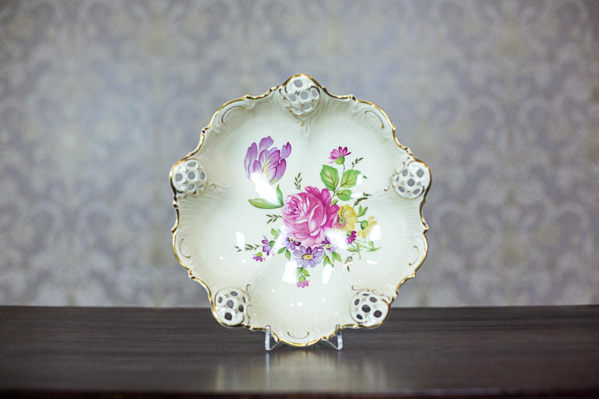 Signature: Rosenthal, Elfenbein, the Moliere series.
This epergne was manufactured in the porcelain manufactory in Kronach, Germany.
The signature indicates that the item was manufactured between 1938 and 1952.
Furthermore, the porcelain in the