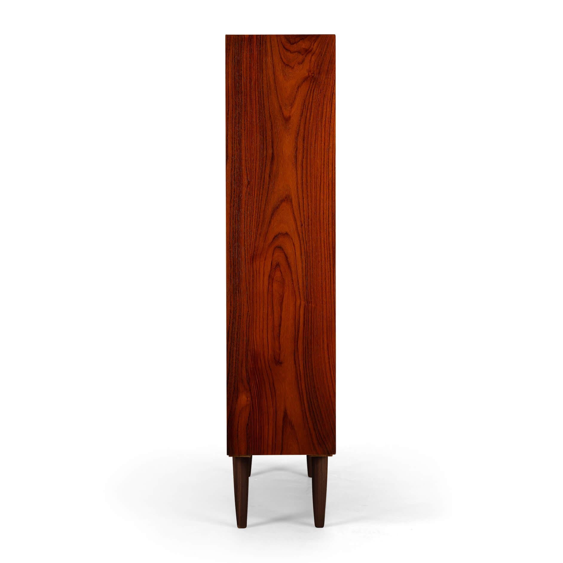 Danish Design
Danish bookcase in beautiful rosewood veneer. Design by IB Kofod Larsen and made by Faarup Mobelfabrik. This bookcase has a total of 8 height-adjustable horizontal shelves. We have two more shelves that are not in this picture. In