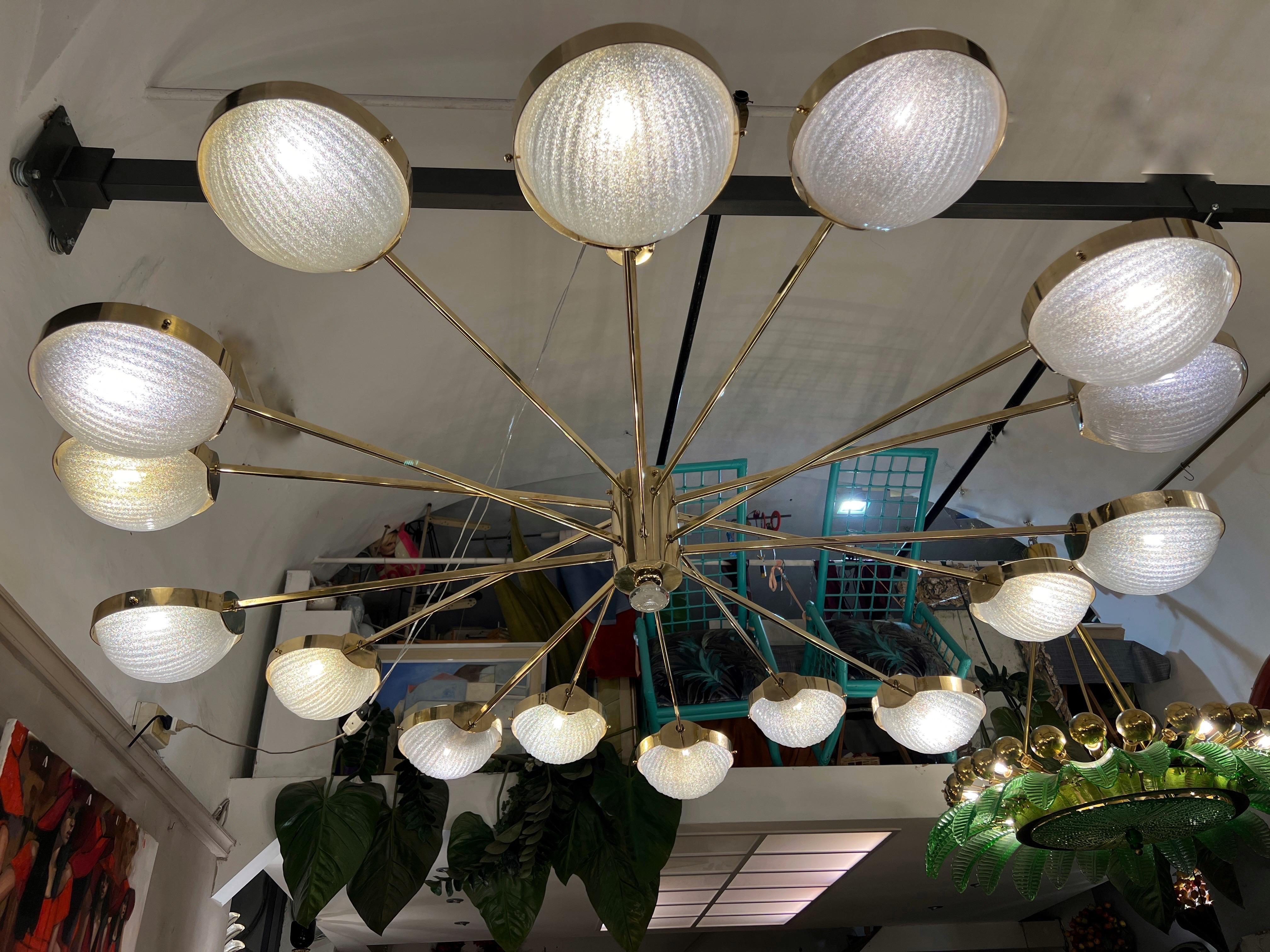 Mid-Century Modern Big Round Murano Clear Glass and Staggered Brass Arms Chandelier 1970 For Sale