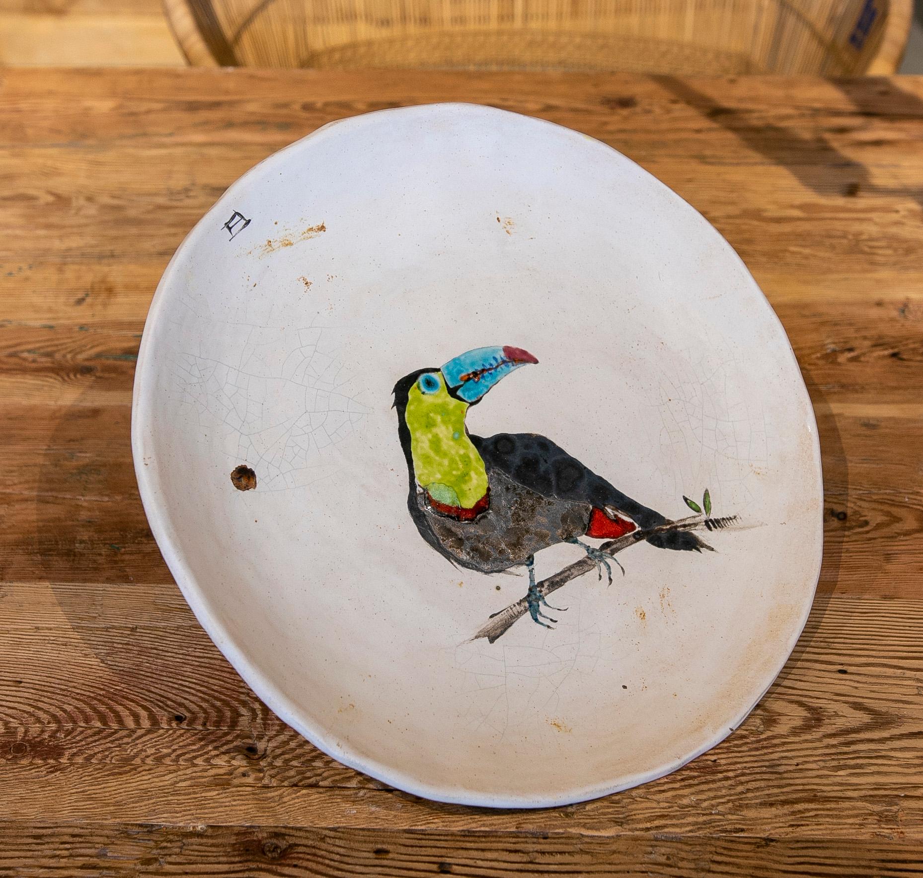 Big round plate in hand painted ceramic with bird.
