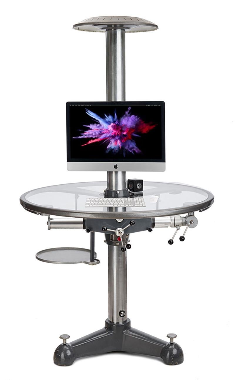 Round work table made from a Cambo photo studio tripod (Dutch brand in professional camera and studio accessories).
This type of column tripod was the first product of this company to be presented in the 1950s.
Workplace for one, two or even three