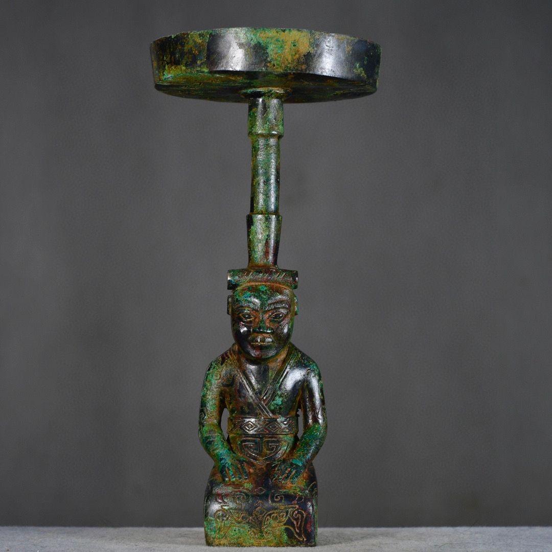 This Big Size Old Asian Bronze Kneeling Down Human Candle Stick Statue is a remarkable work of artistic craftsmanship and functional design. The statue features a kneeling human figure holding a candle holder, exuding grace, humility, and spiritual