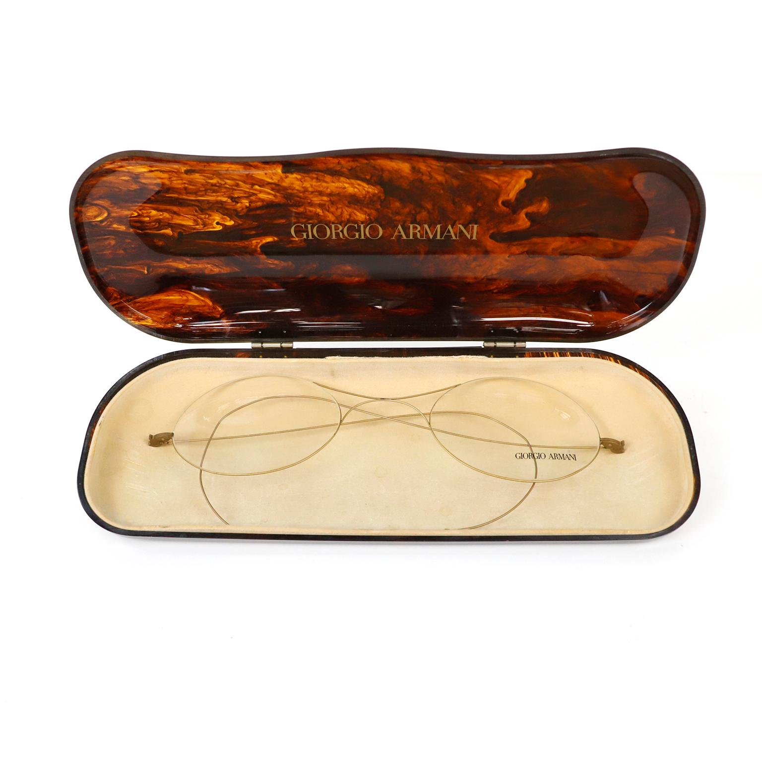 We offer this very large mid-twentieth century French faux tortoise shell glass case factice features a pair of large wire rim glasses. Both the case and glasses are marked Georgio Armani. Originally created by Armani for a designer eyewear shop in