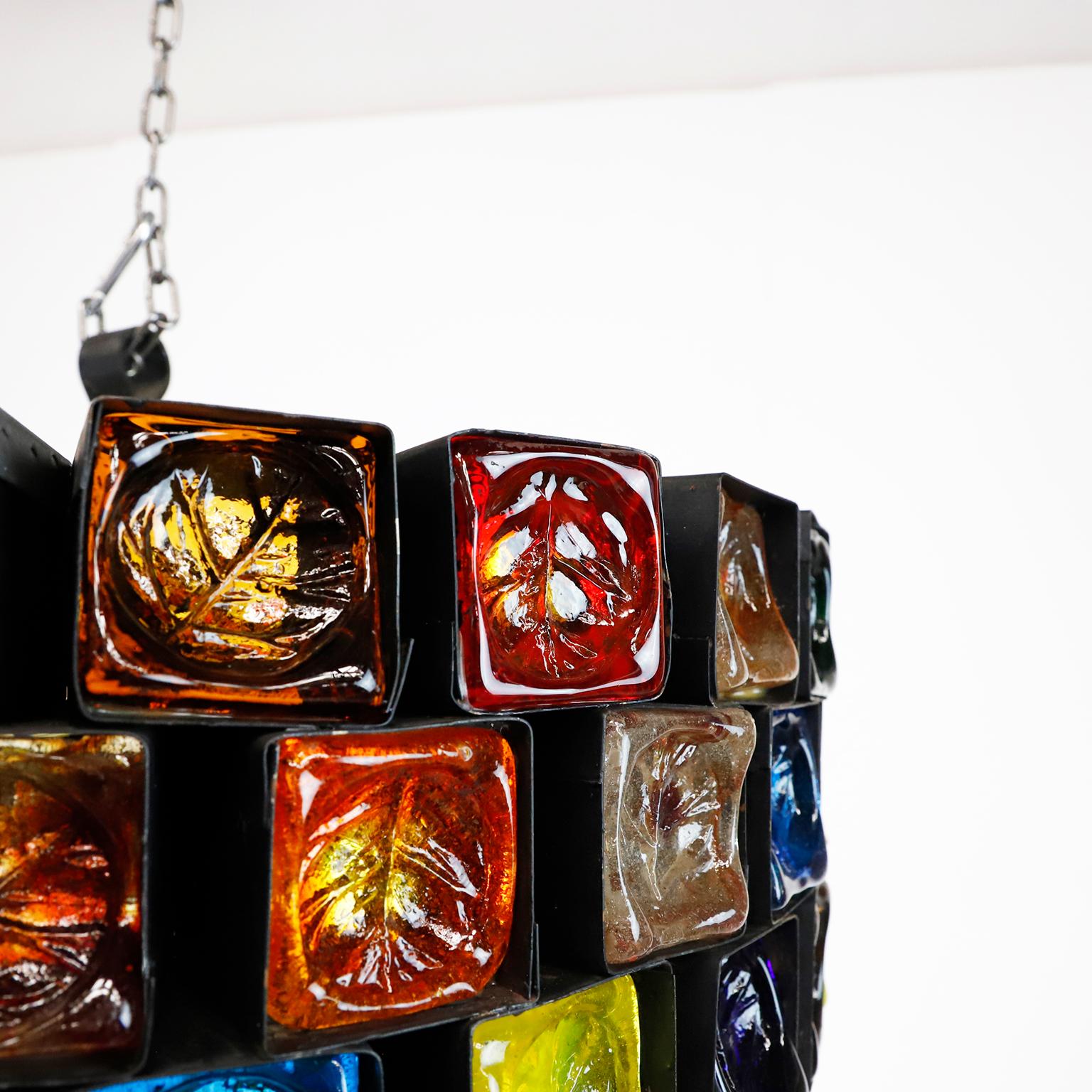 We offer this big size chandelier, made of steel and multicolored blown glass in fantastic vintage conditions, each cube is handwrought in steel which cradles the thick sculptured glass, the chandelier have 72 cubes of glass measures 6 x 6 cm, circa