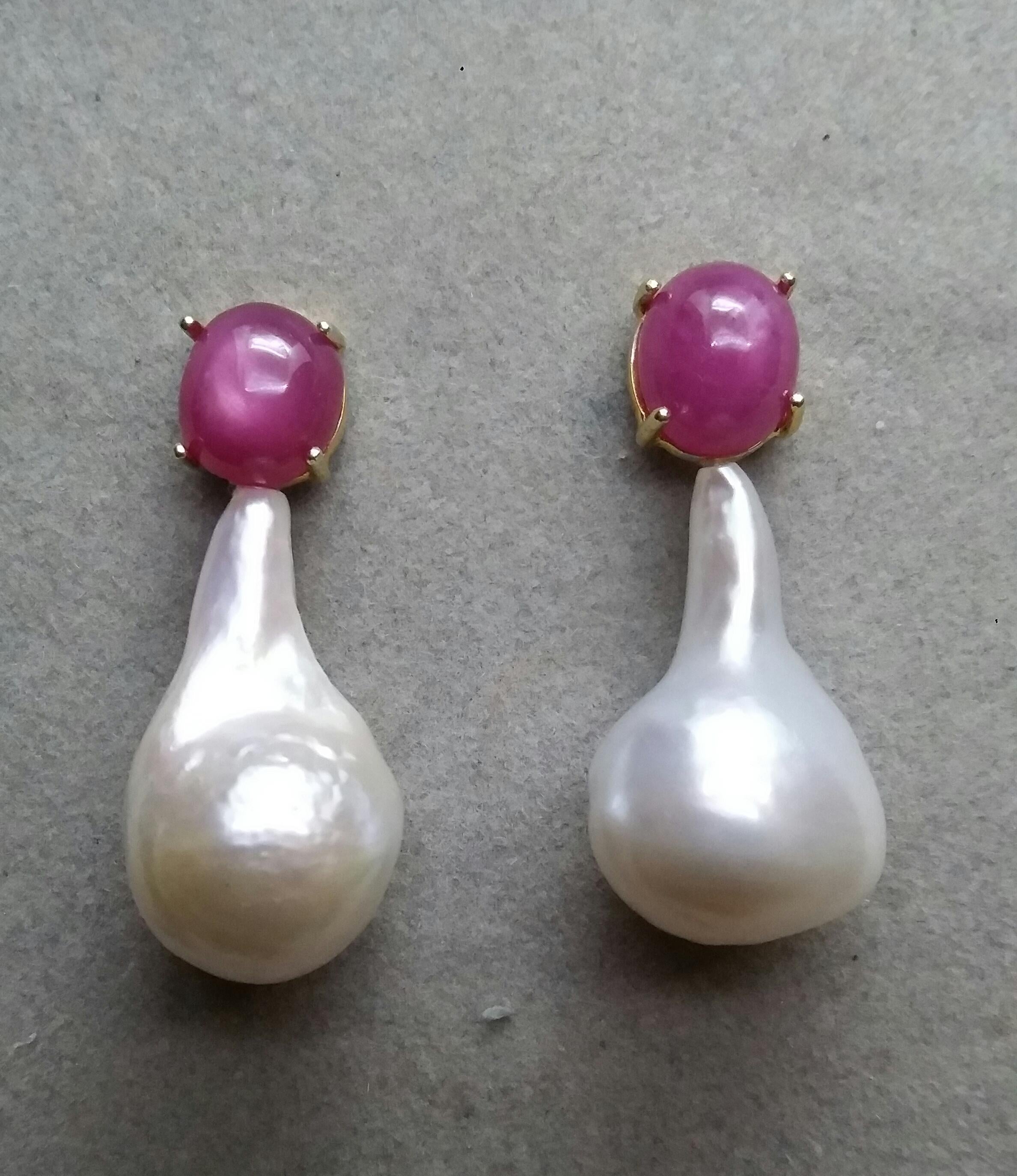 Simple chic stud earrings with a pair of Oval Ruby Cabs measuring 10 x 11 mm set in solid 14 Kt. yellow gold on the top and in the lower parts 2 unusual shape , big size and excellent luster White Pear  Baroque Pearls measuring 16 mm x 28 mm and