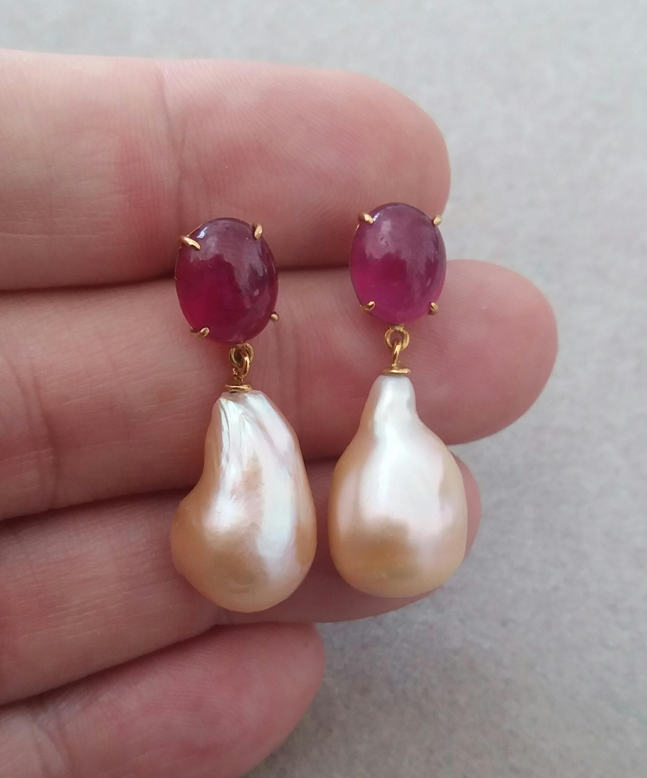 Simple chic  earrings with a pair of Oval Ruby Cabs measuring 8 x 10 mm set in solid 14 Kt. yellow gold on the top and in the lower parts 2  big size and excellent luster Cream Color Pear Shape  Baroque Pearls measuring 13 mm x 19  mm and weighing 