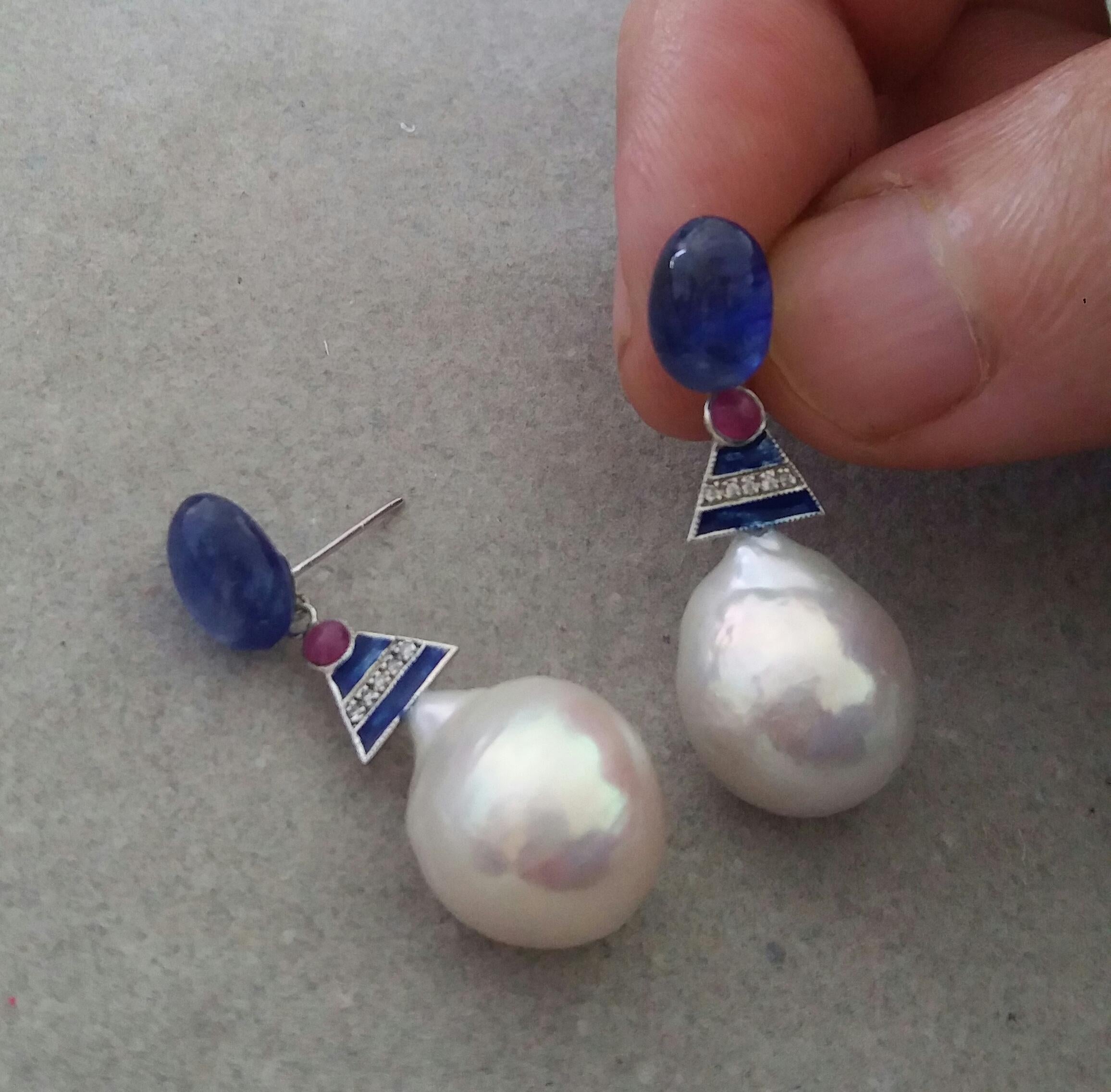 2  Blue Sapphire oval cabs 7,5 x 10 mm. are the upper parts, then the central parts are in white gold,2 small round ruby cabochons, 10 round full cut  diamonds and Blue Enamel, the lower parts are composed of 2 Big White Baroque Pearls with a
