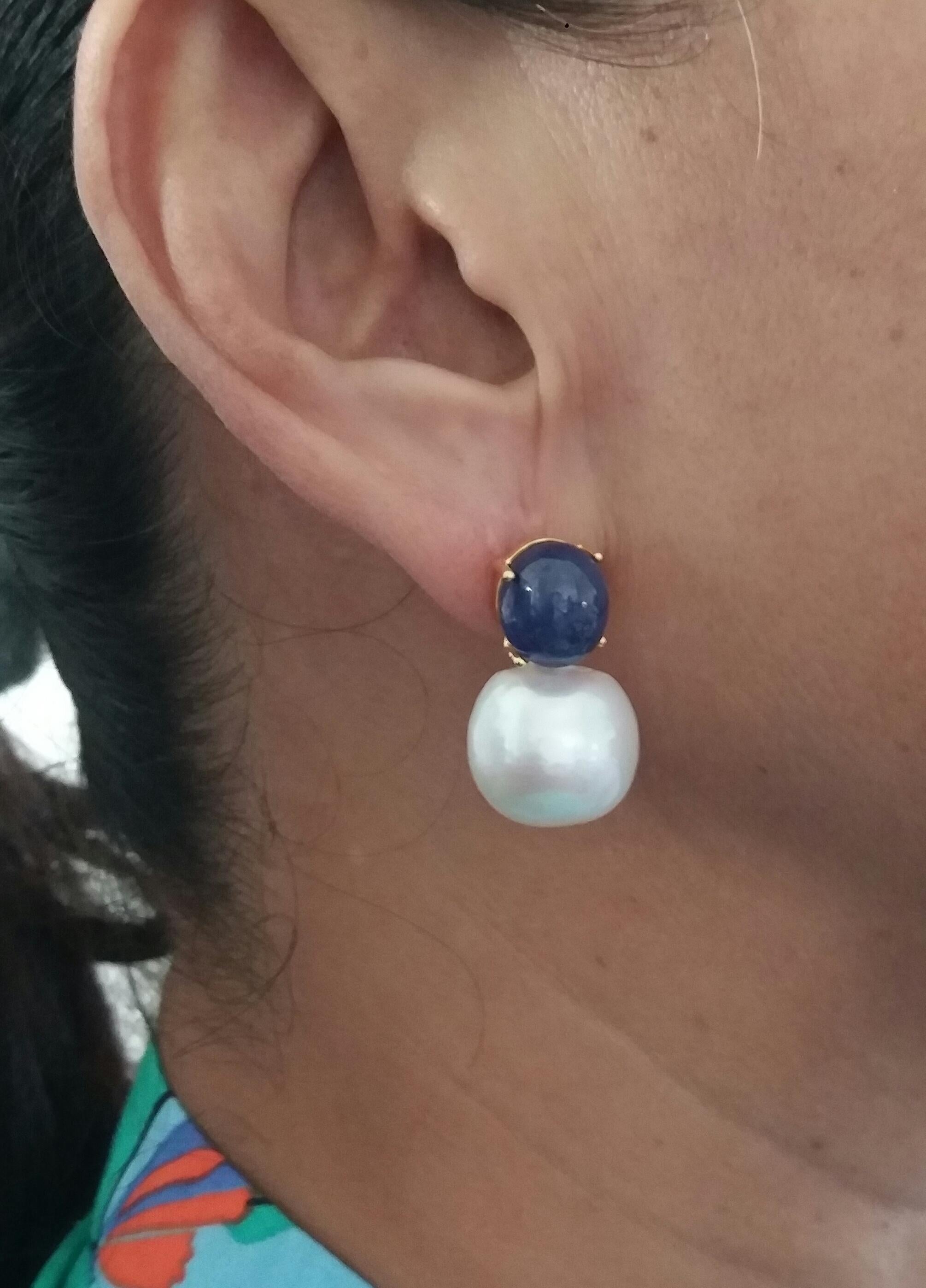 Simple chic stud earrings with a pair of Oval Blue Sapphire Cabs measuring 10 x 11 mm set in solid 14 Kt. yellow gold on the top and in the lower parts 2 unusual  big size and excellent luster White Baroque Pearls measuring 16 x 17 mm and weighing