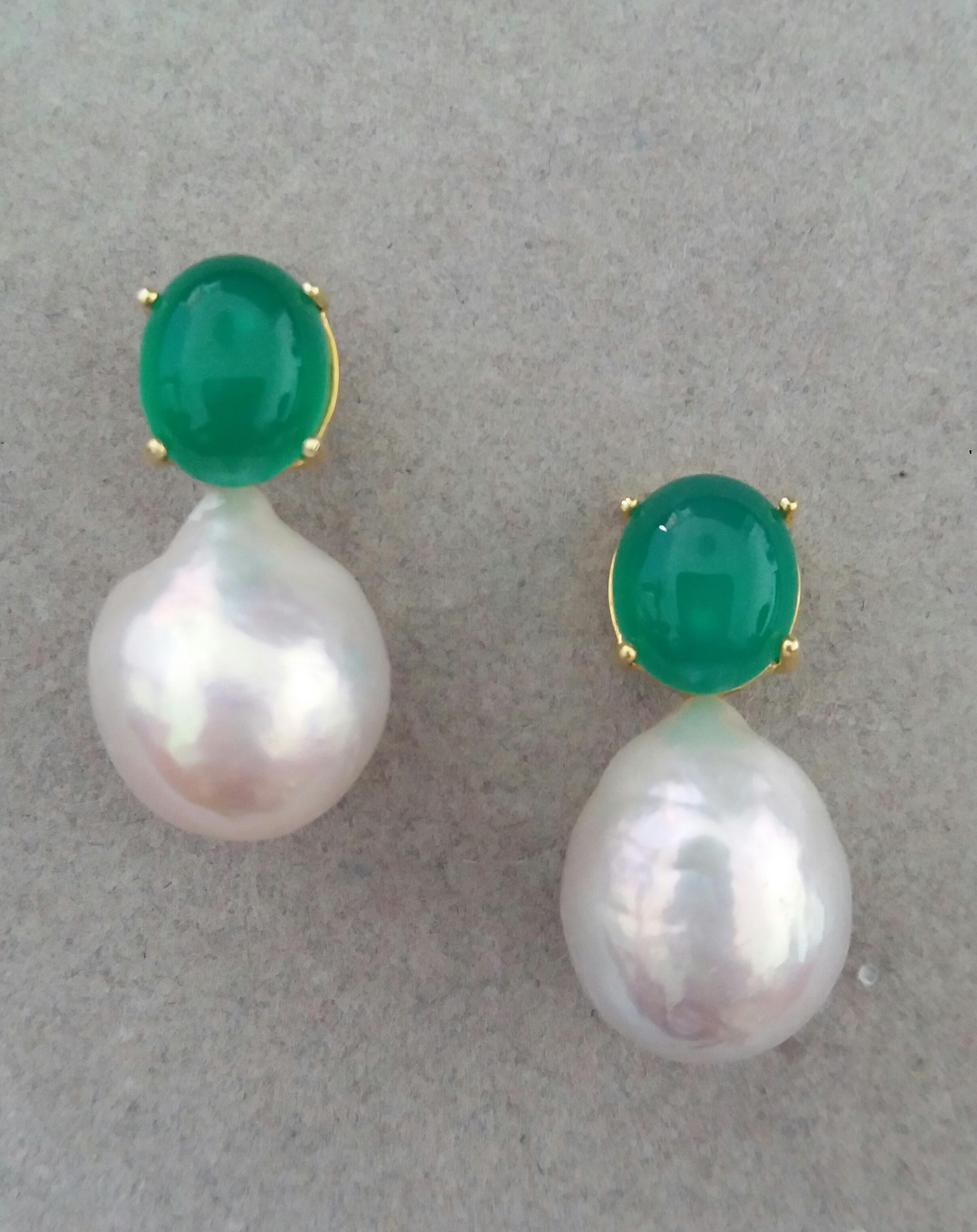 Simple chic stud earrings with a pair of Oval Green Onyx Cabs measuring 9 x 11 mm set in solid 14 Kt. yellow gold on the top and in the lower parts 2 unusual big size and excellent luster White Baroque Pearls measuring 14 x 17 mm and weighing 57