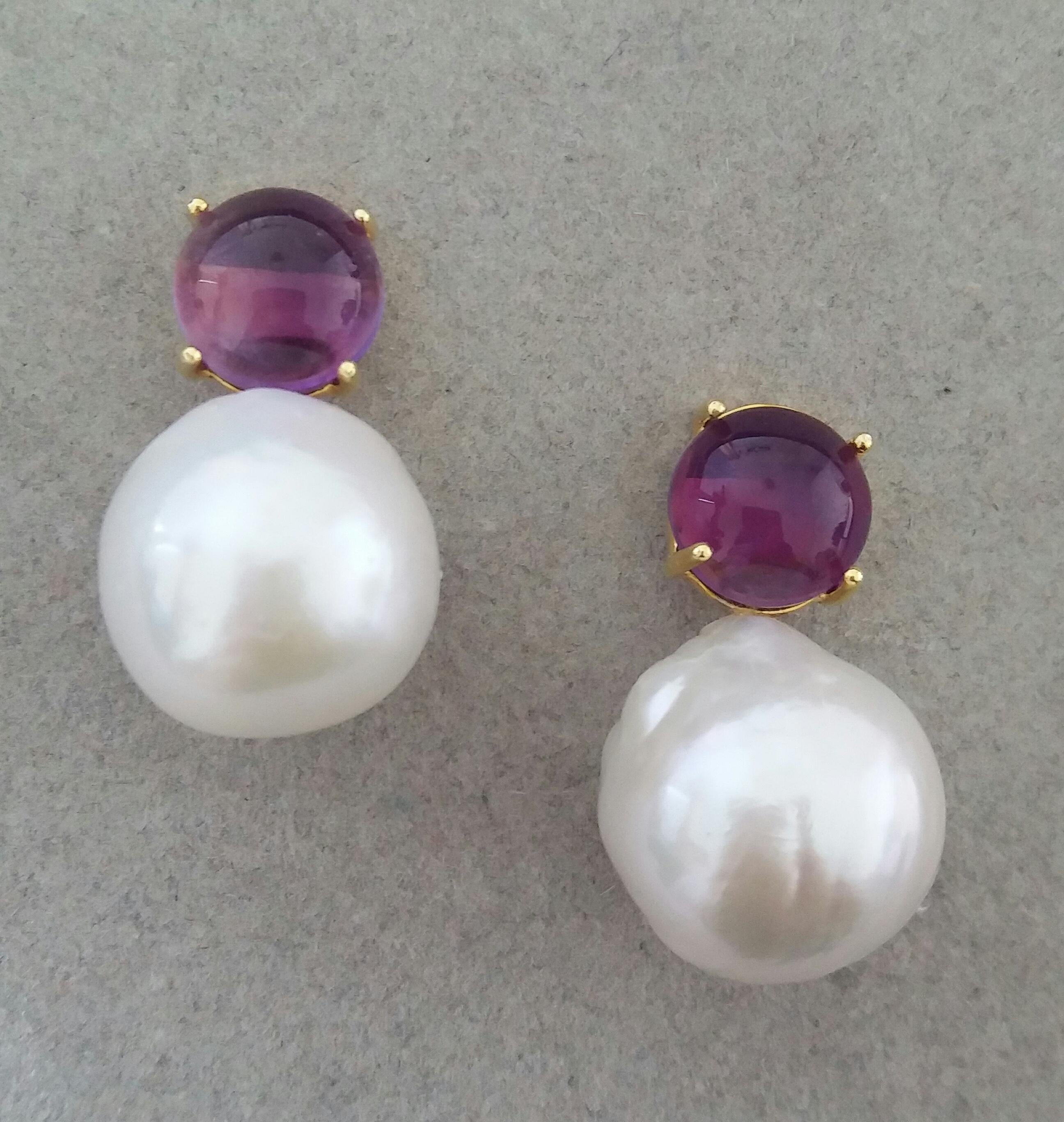 Simple chic stud earrings with a pair of Round Amethyst Cabs measuring 10mm in diameter set in solid 14 Kt. yellow gold on the top and in the lower parts 2 unusual big size and excellent luster White Baroque Pearls measuring 16 mm in diameter and