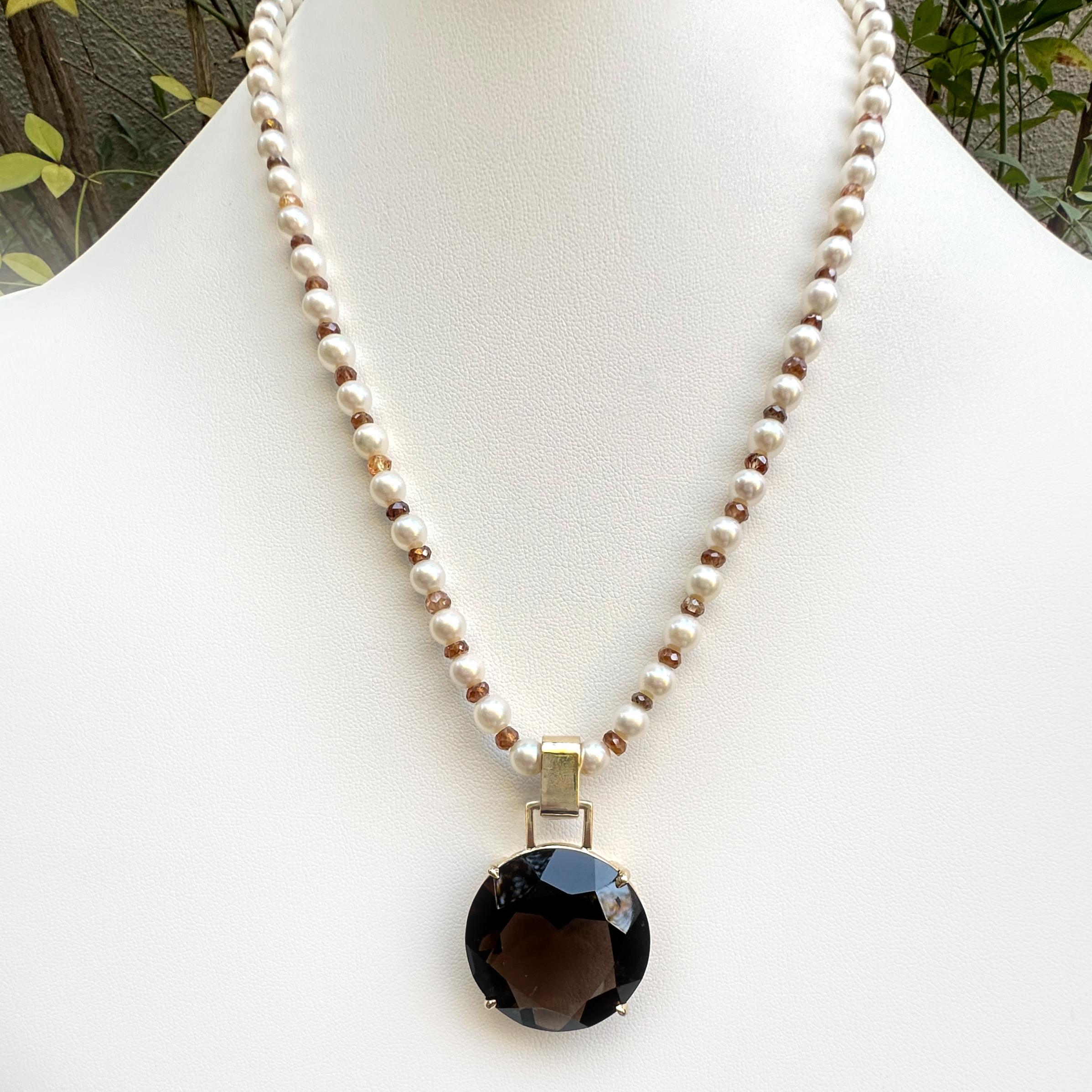 This ridiculously large smoky quartz came into the shop inside of a customer's very heavy, poorly conceived 1970's gold pendant.  The customer wanted the gold value of the pendant applied to her custom piece and she didn't want the quartz stone. 