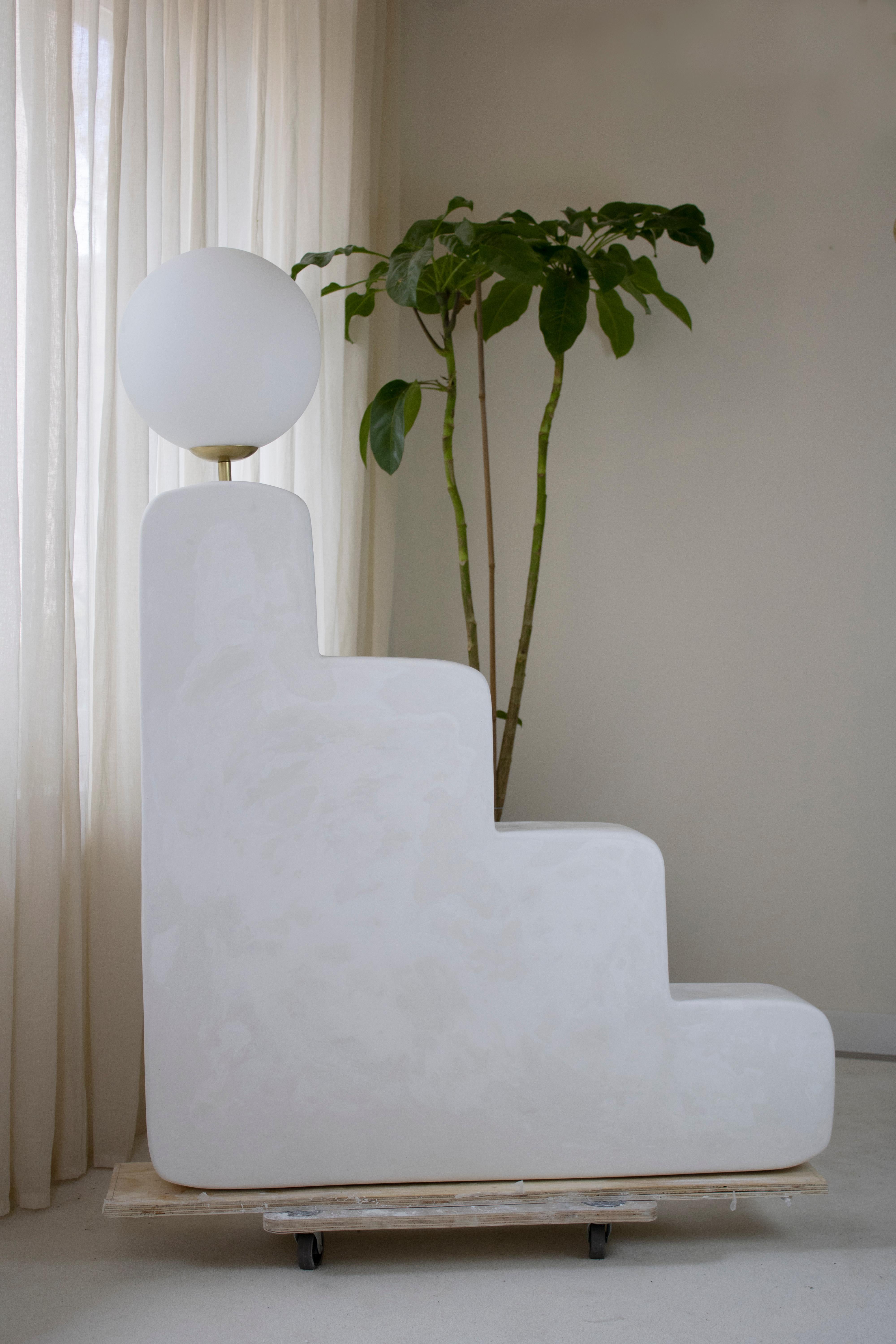 Big Step lamp by AOAO
Dimensions: W 100 x D 16 x H 135 cm
Materials: White plaster
Color options available upon request.

The idea was born after deciding to reconnect with my family and my grandfather – a sculptor artist. Learning to sculpt