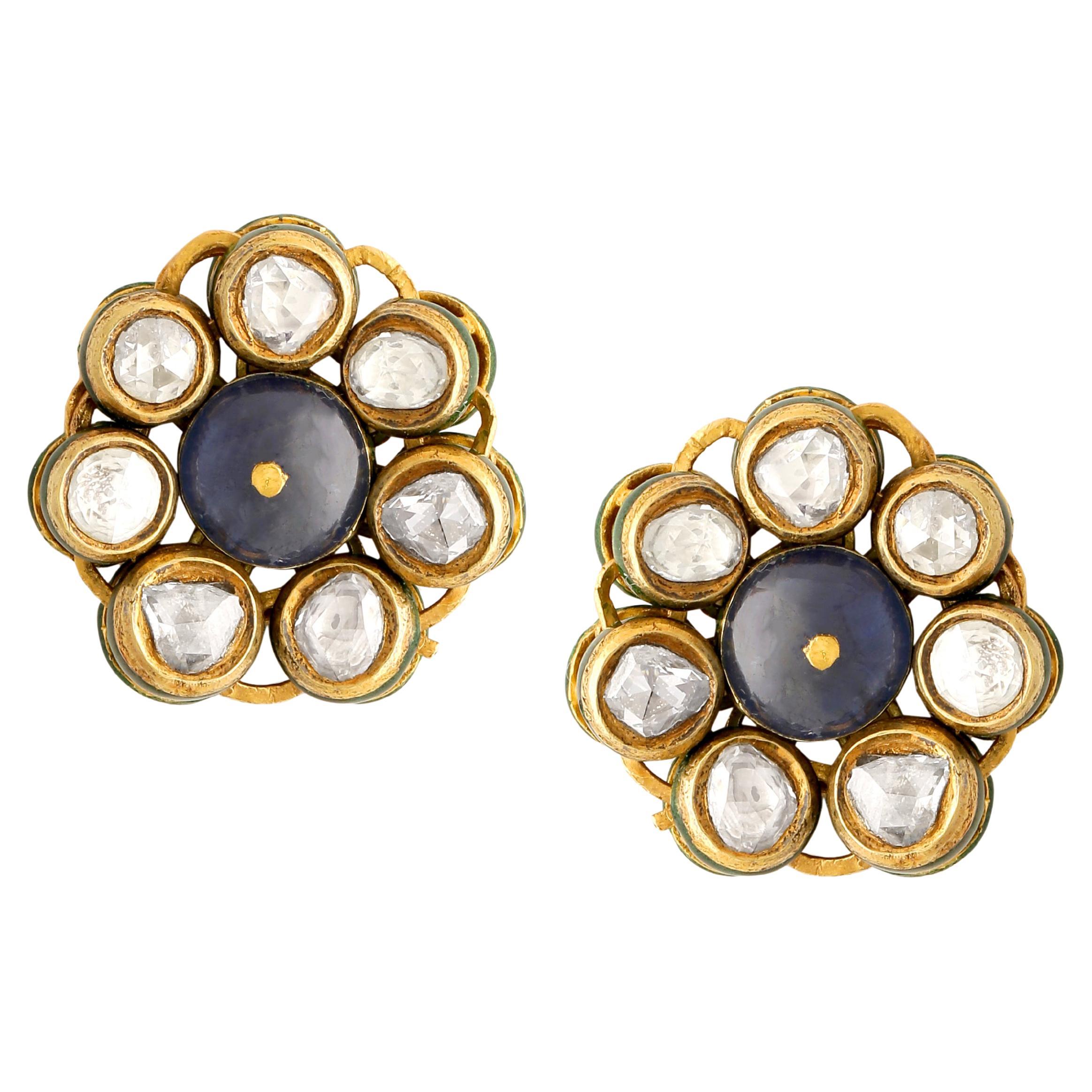 A pair of important studs with a pair of Burmese Natural Sapphire beads in the centre and Rose cut diamonds all around it. The earring is handcrafted in 18Karat yellow gold and has beautiful and intricate enamel work at the back. the enamel work is