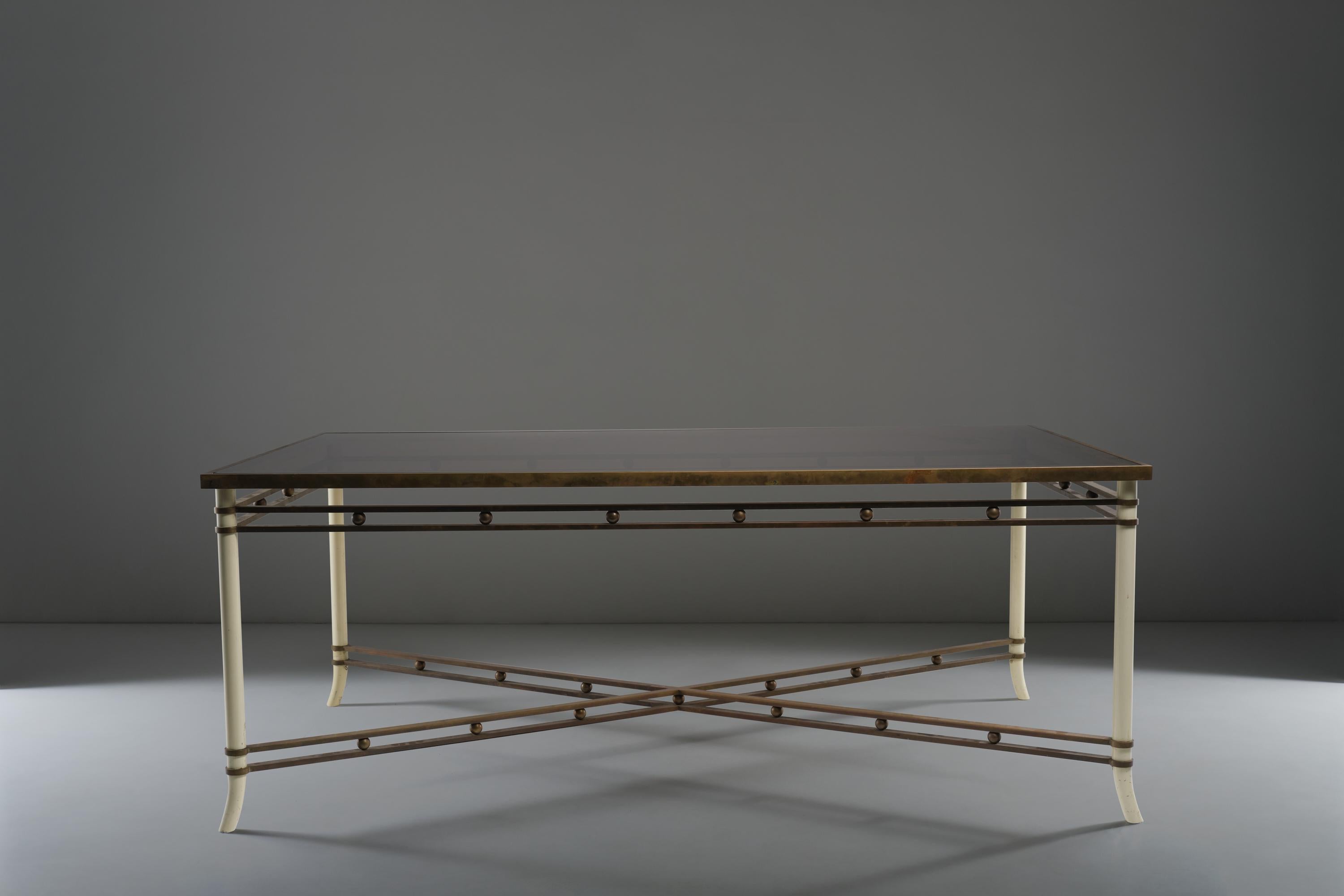 Attributed to Romeo Rega, this big table perfectly merges the stability of the structure with the elegance of its lacquered wood and brass legs. The rigorous use of plain lines and geometrical elements reflects the typical Romeo Rega style, based on