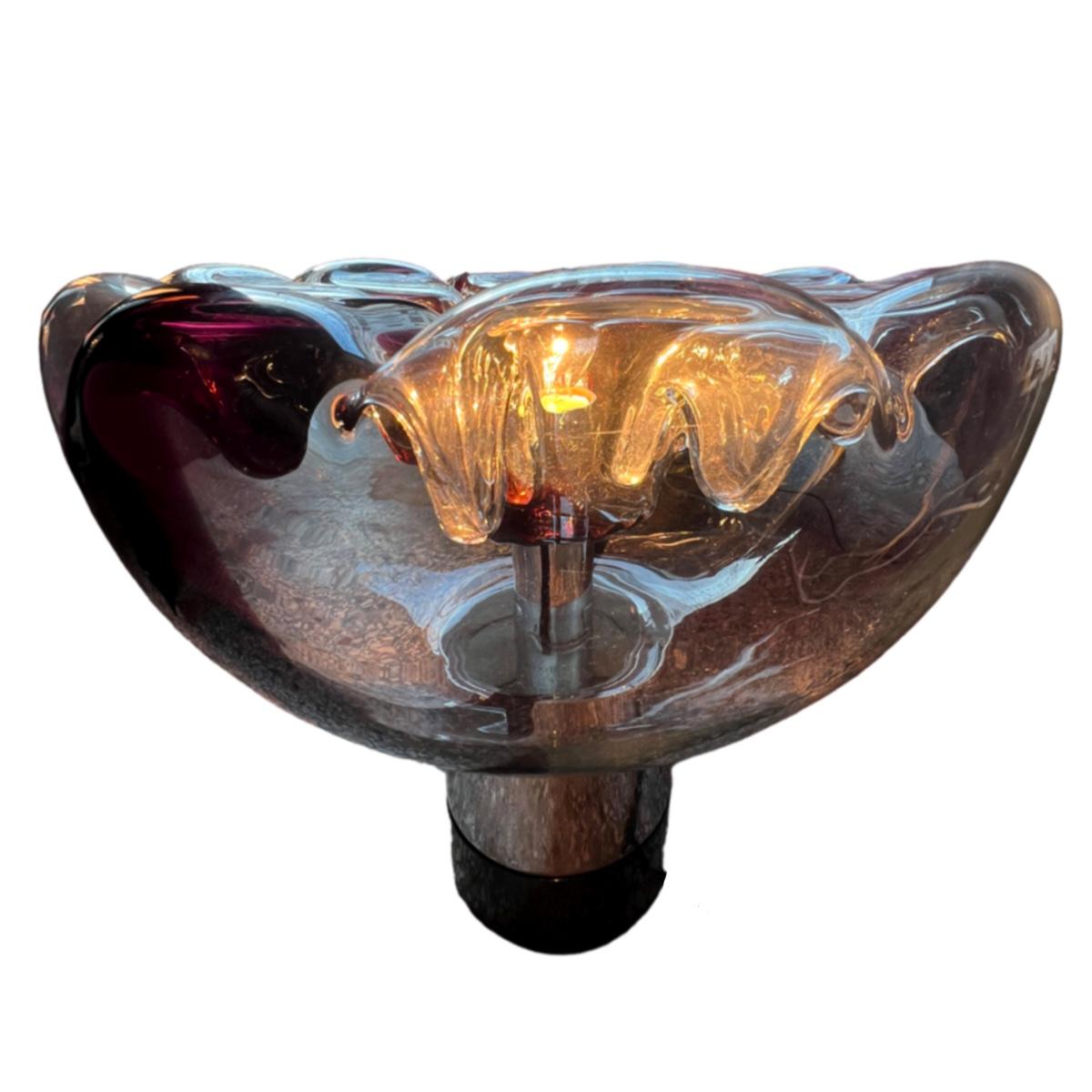 Very large table lamp by the famous glass designer, Toni Zuccheri, for the Italian company VeArt.
The mouth-blown glass is two-colored, transparent and dark Bordeaux.
From the top glass cones are hanging downwards, giving an incredible lighting