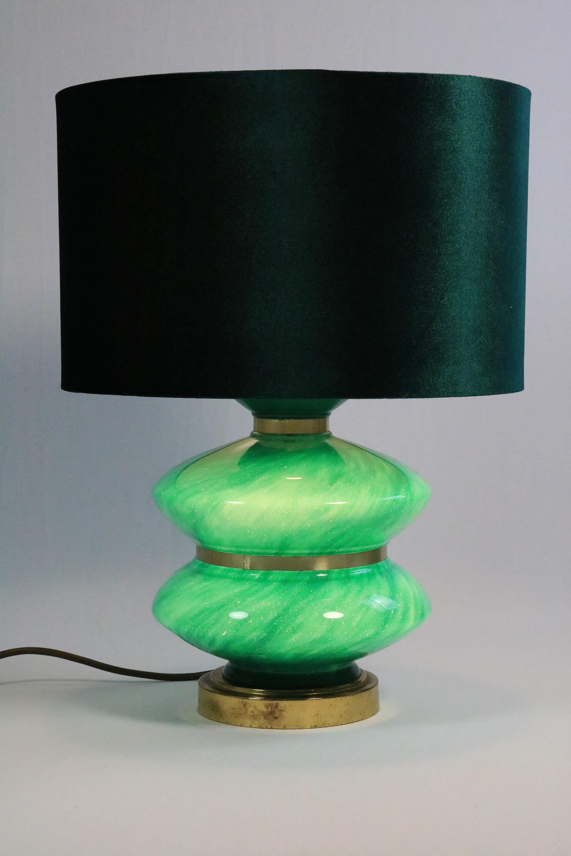 Interesting large table lamp with green glass base that lights up.
 
The two sockets (lampshade and glass base) can only be switched together.
 
The green velvet shade matches the color perfectly, but is not original. The socket sits a little too