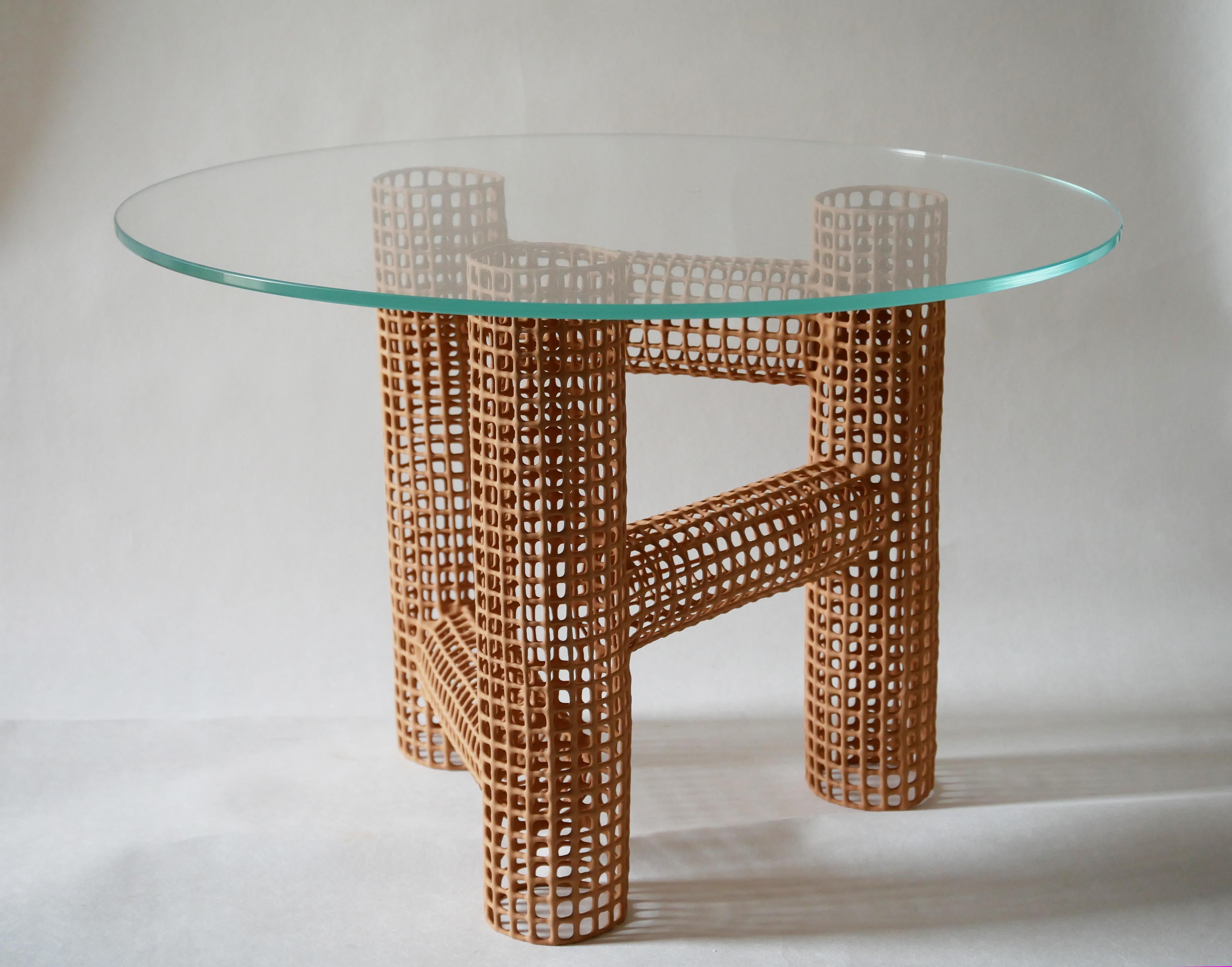 Big Tripod Coffee Table by Dzovag Kotchian
Dimensions: W 60 x D 60 x H 38 cm
Materials: Stabilized Raw Clay, Metal, Glass.

Dzovag Kotchian's work develops through theoretical reflection and artistic research. Experimentation with materials, uses