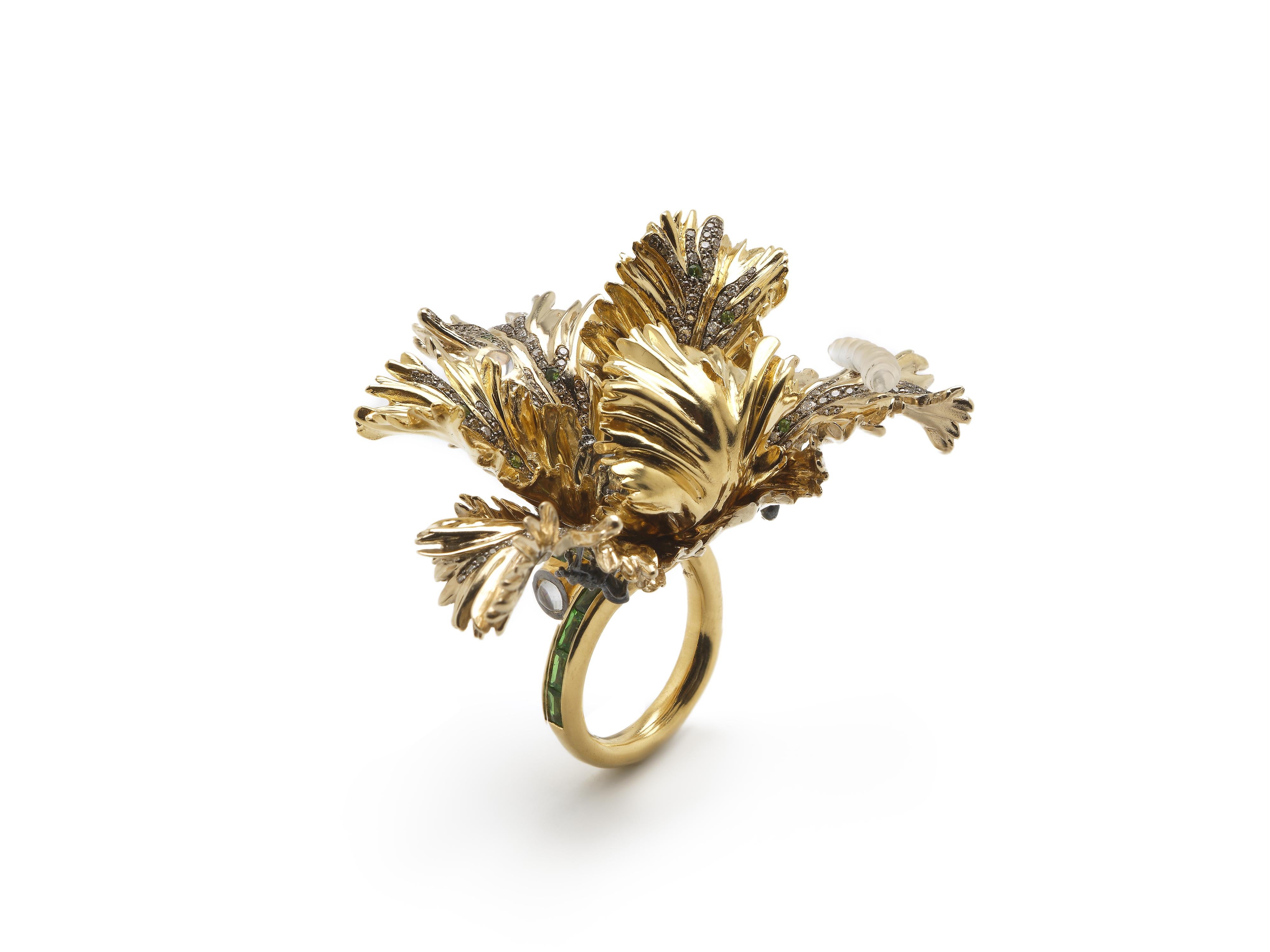 Inspired by the flamboyant beauty of the Parrot Tulip, the Big Tulip Ring blooms over the hand, for a unique take on a cocktail ring. 

The ring’s petals are designed in 18k white and yellow gold with blackened gold detailing, and embellished with