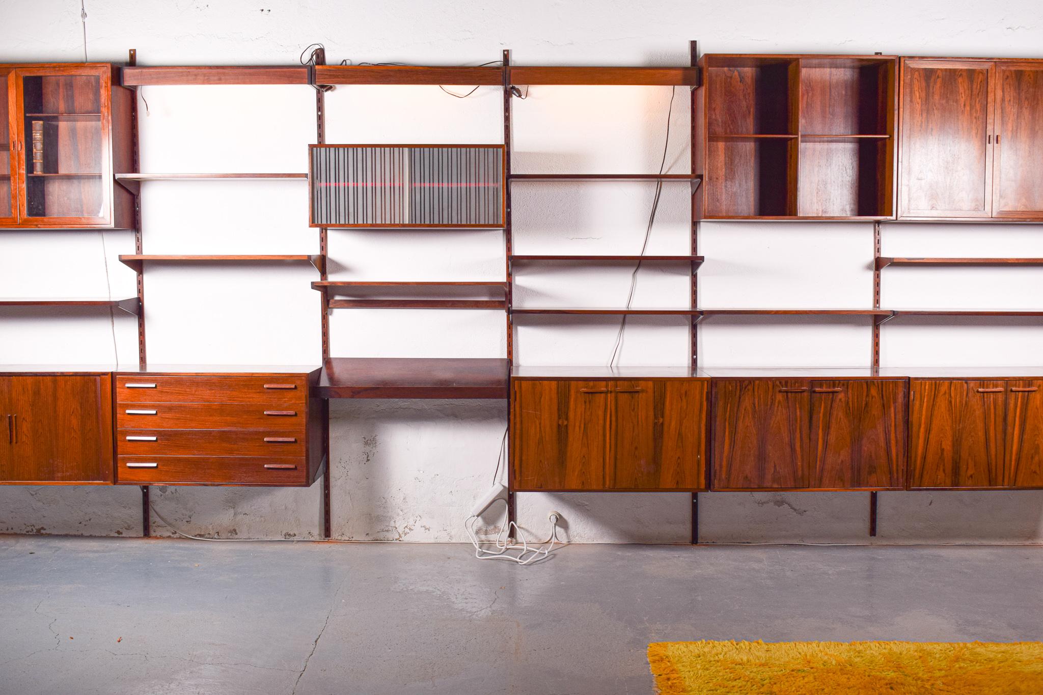 Danish rosewood wall unit designed by Kai Kristiansen for FM Mobler. The unit has 6 modules with: 3 door cabinets, one of them opens on the top, 1cabinet with sliding doors, 1 cabinet with 4 drawers, 1 open cabinet with shelves, 1 cabinet with