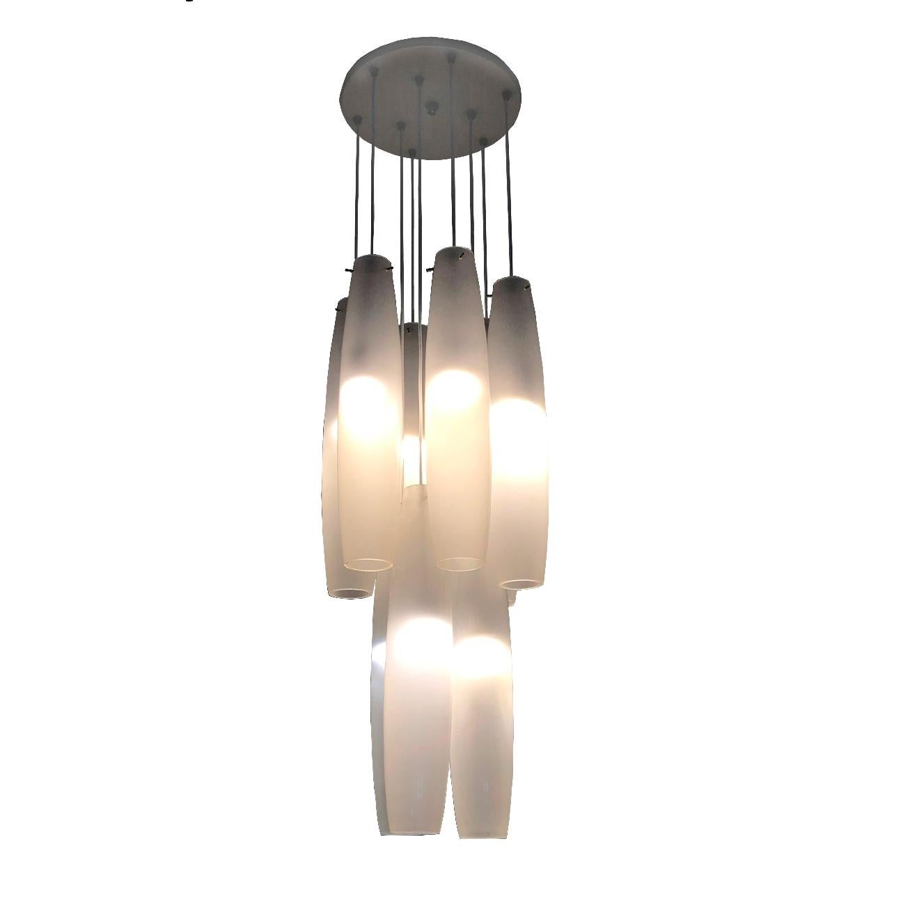 Very big chandelier consisting of 9 white pendants. Each pendant is 65 cm (25.5 in) long and 14 cm (5.5 in) in diameter.
Nine tubes are attached to a beige enameled metal ceiling rose which is fastened to the ceiling by chrome-plated nut.
The